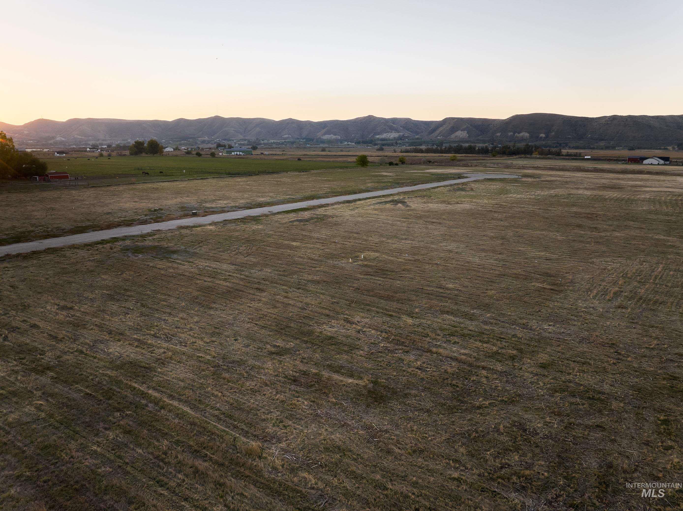 View of mountain backdrop featuring rural landscape