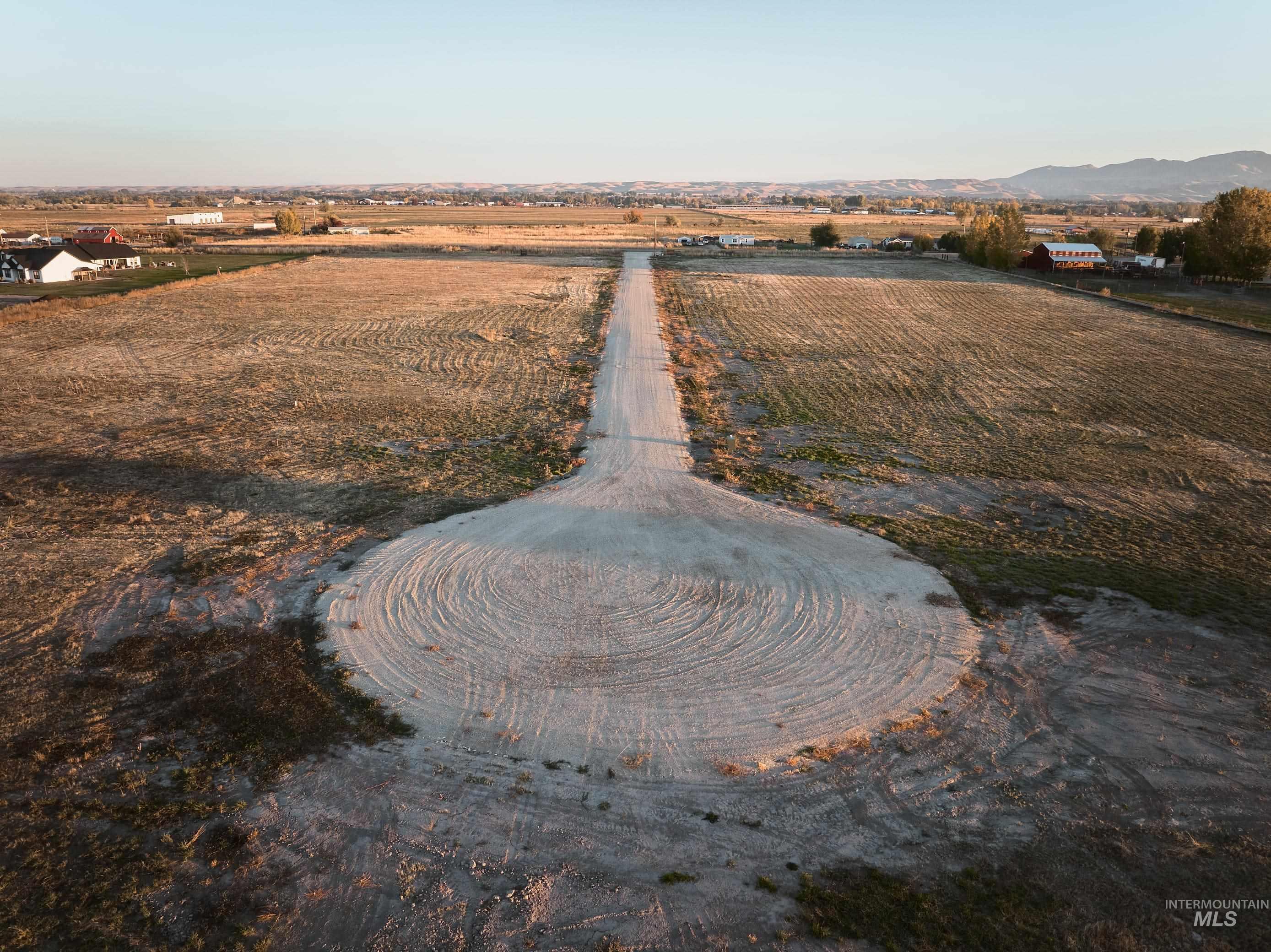 Aerial view of property's location with rural landscape, abundant farmland, and mountains