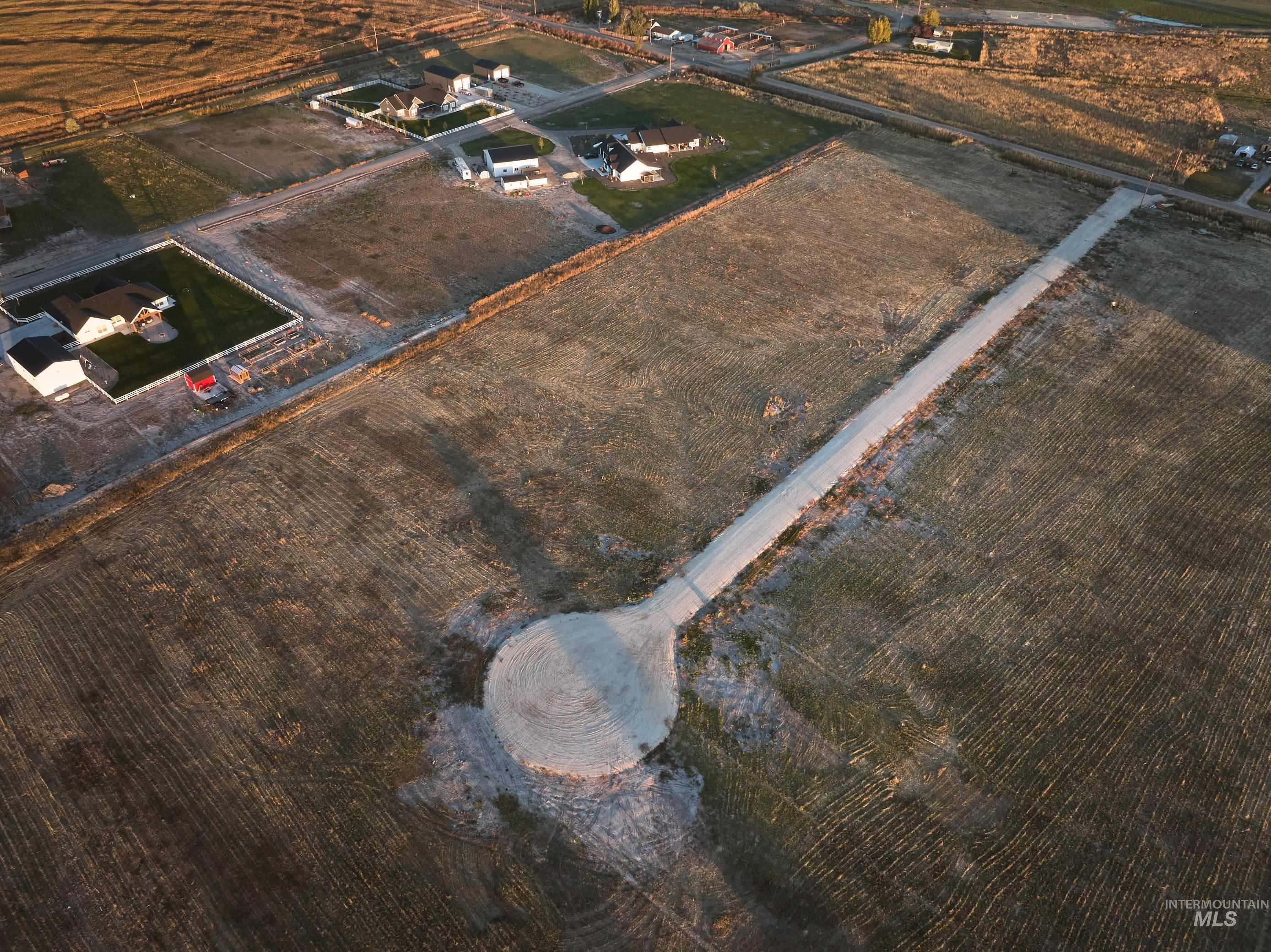 Aerial view of sparsely populated area with large plots for crops