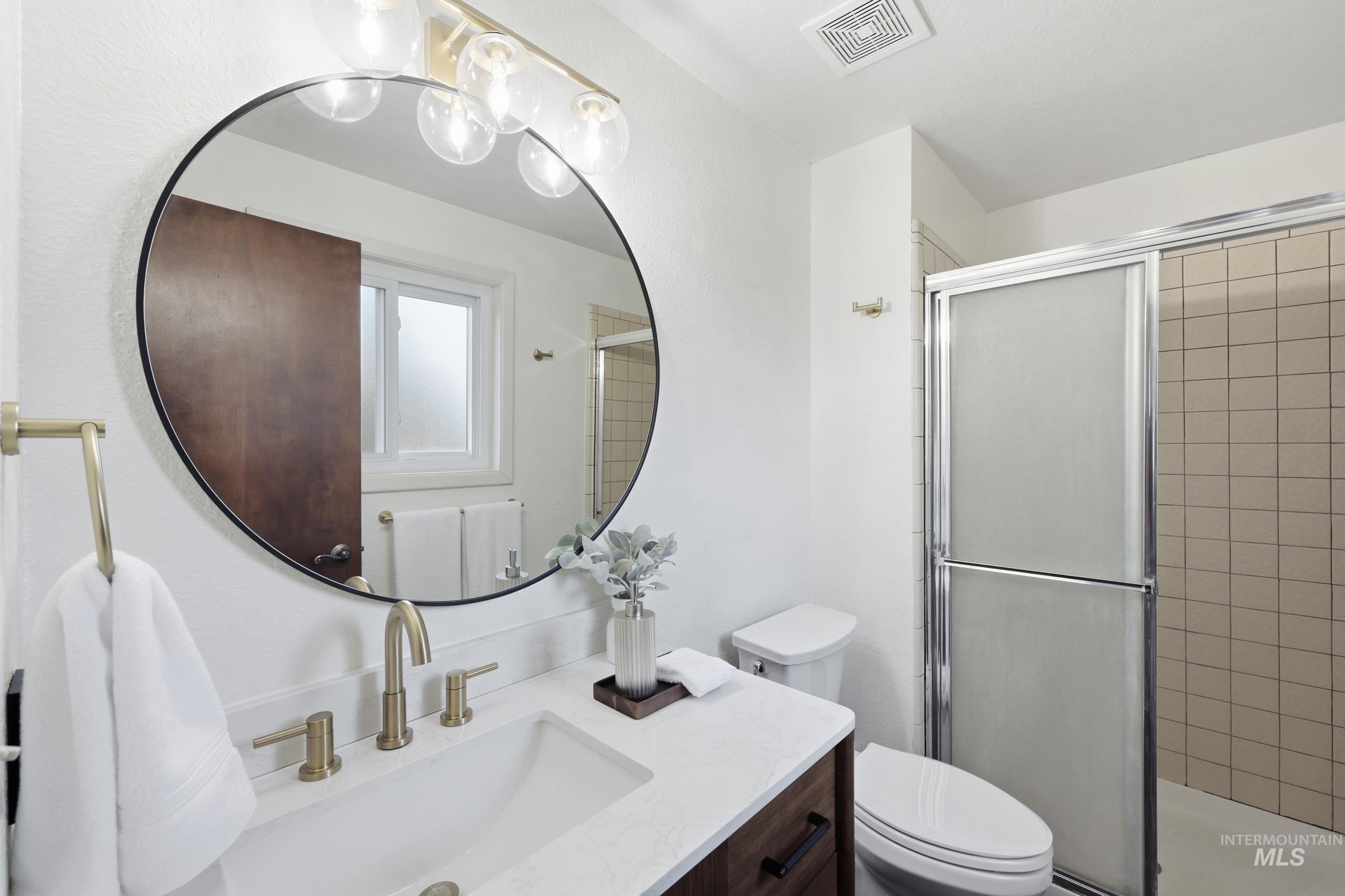 Master bathroom with updated vanity and a full shower.