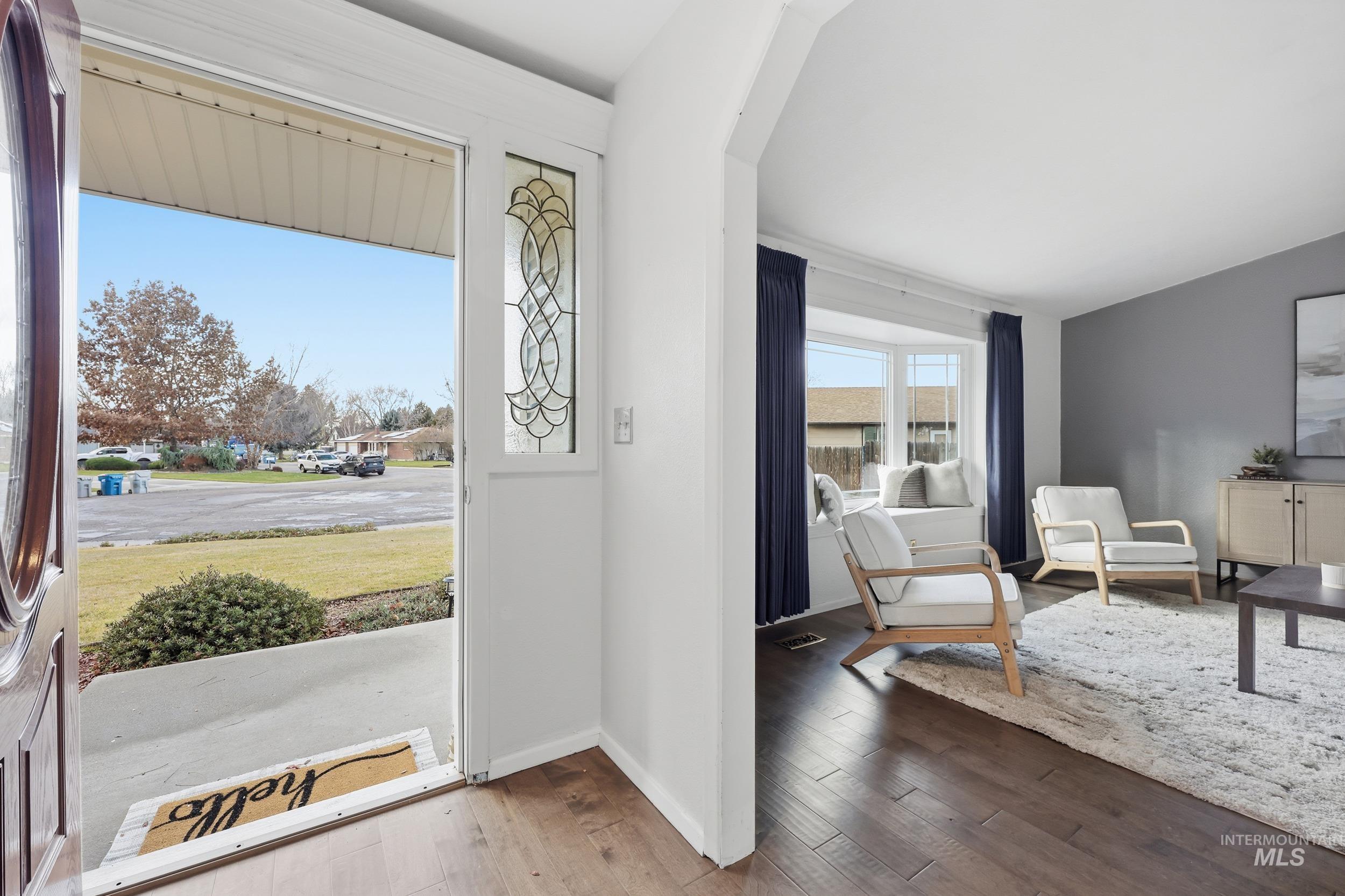 Entryway with new engineered wood flooring and an arched walkway into the living room.