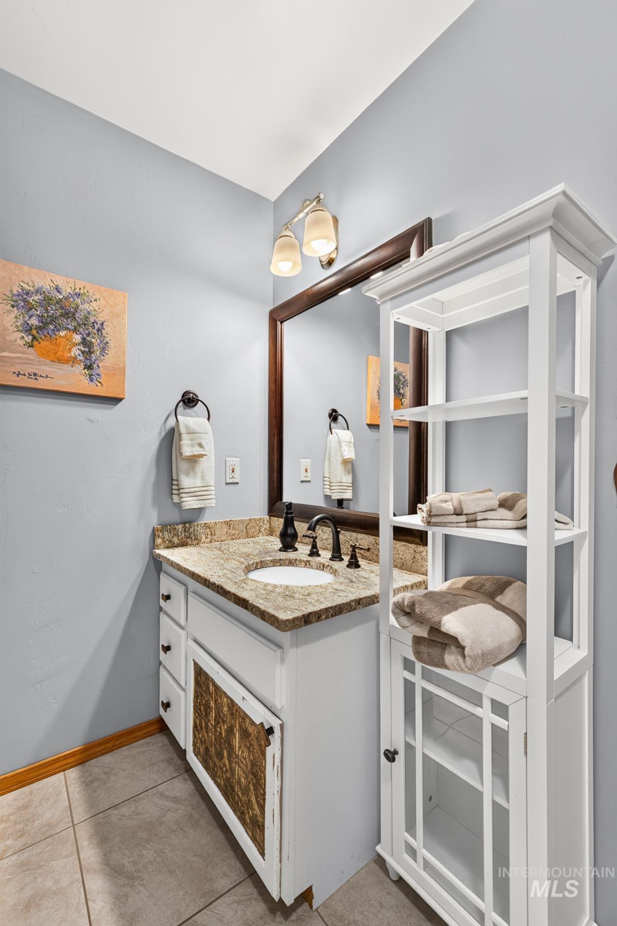 Single vanity with a granite countertop and an undermount sink