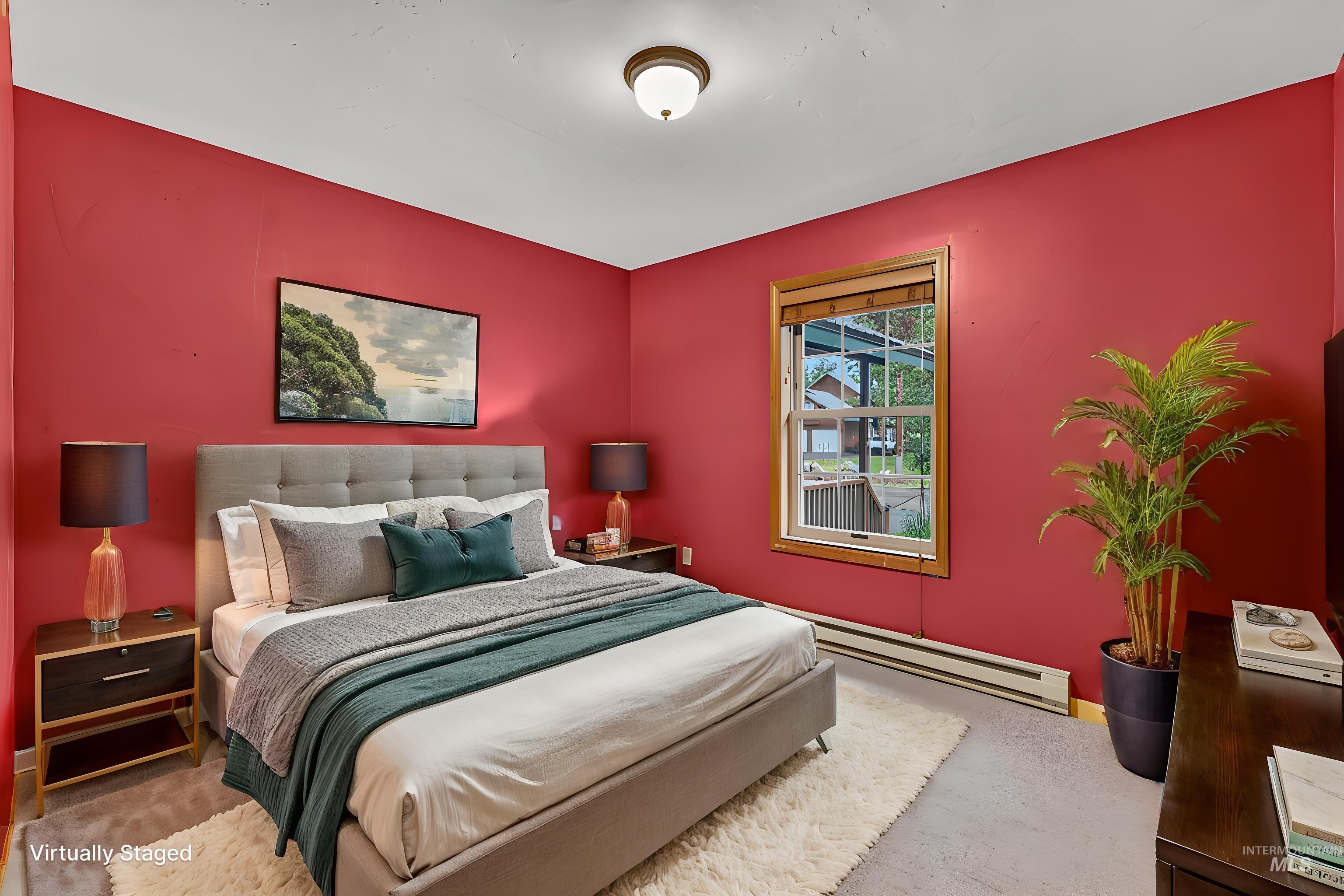 Bedroom featuring a bright wall color, wood-trim window, and a ceiling-mounted light fixture