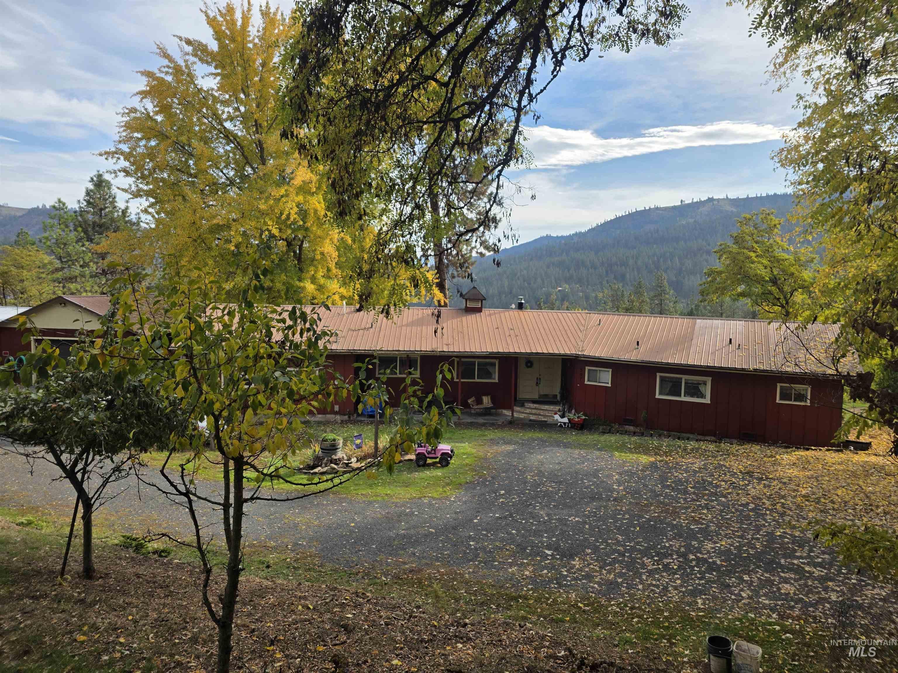 Single story home featuring a mountain view and a metal roof