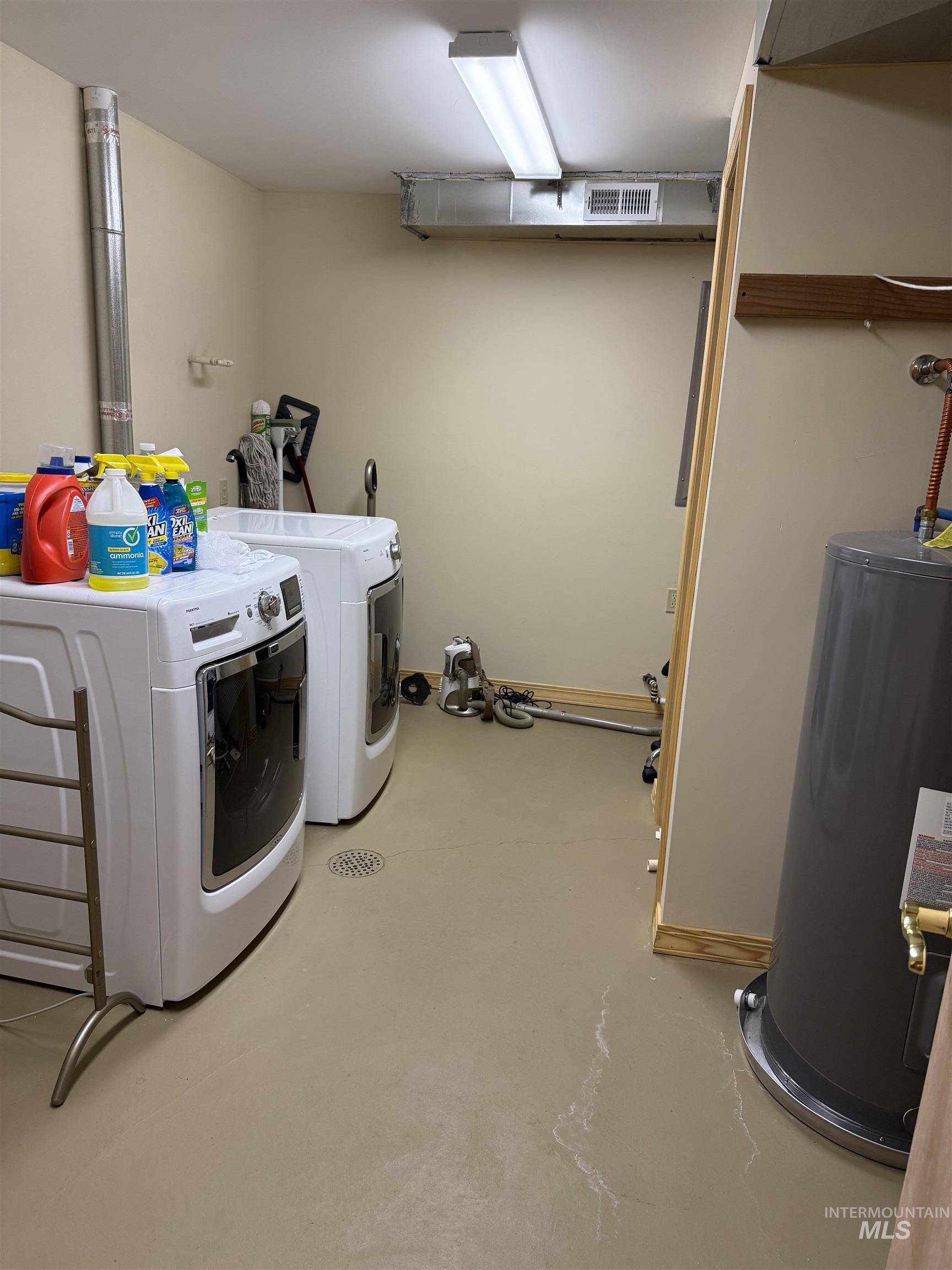 Laundry area featuring water heater and washer and dryer
