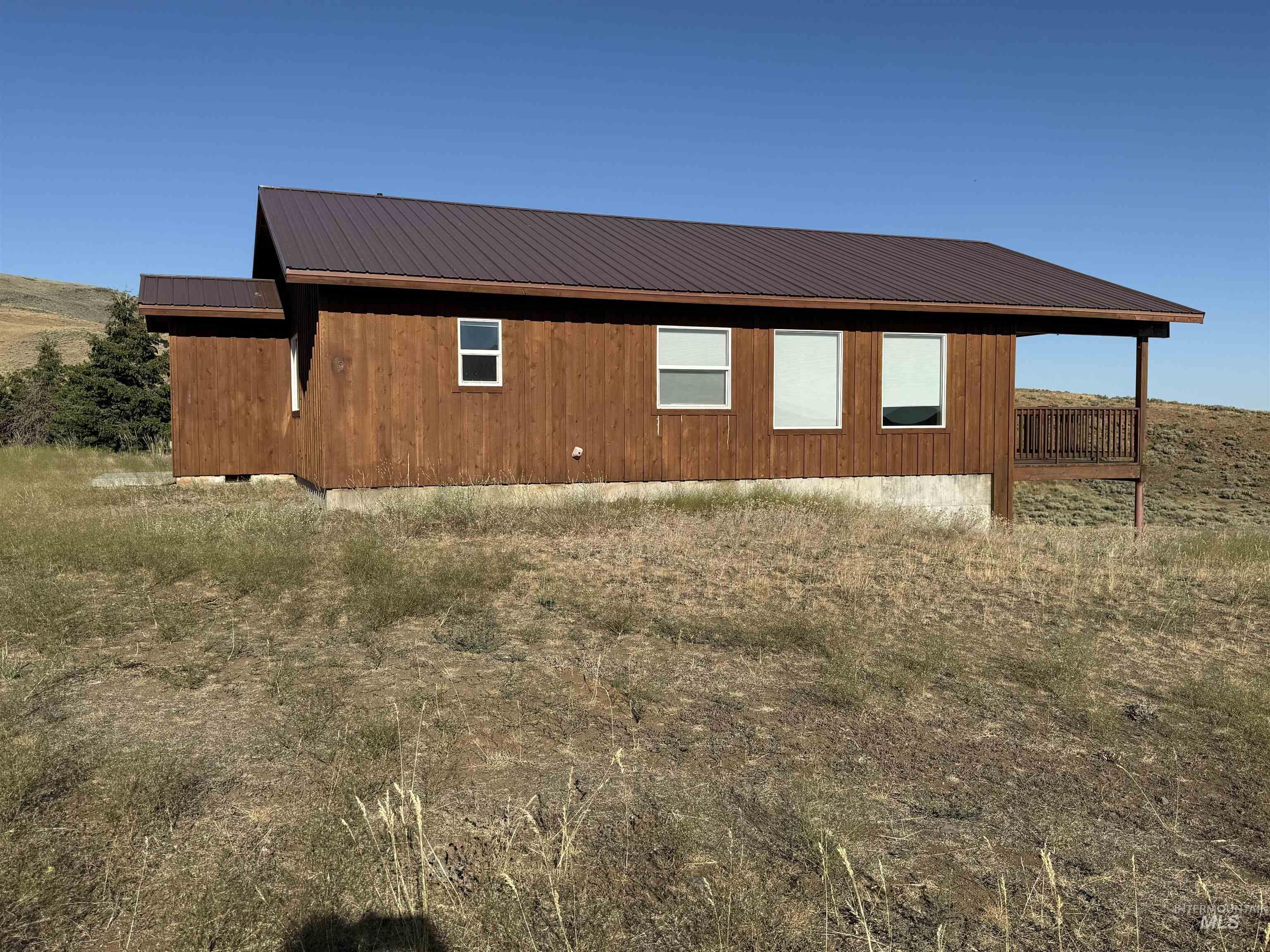 View of property exterior featuring a metal roof