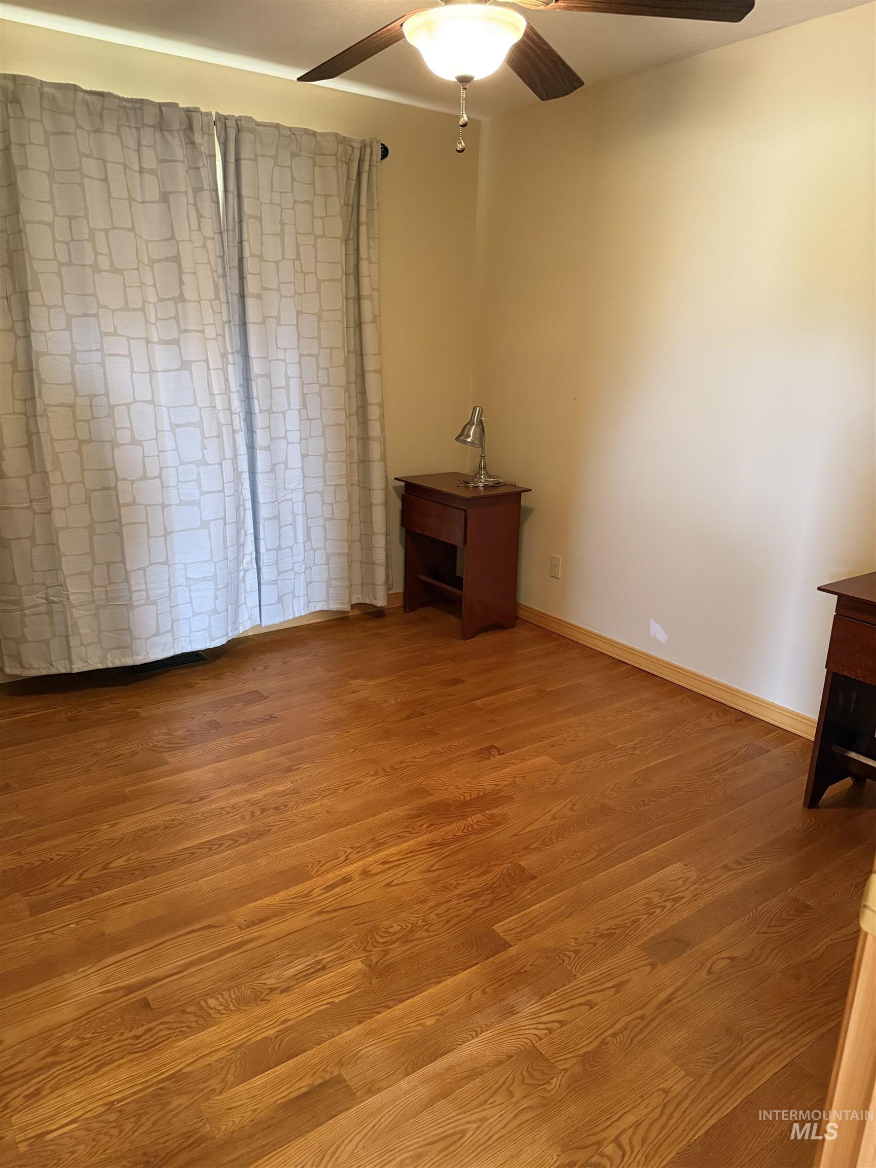 Unfurnished bedroom with light wood-type flooring and a ceiling fan