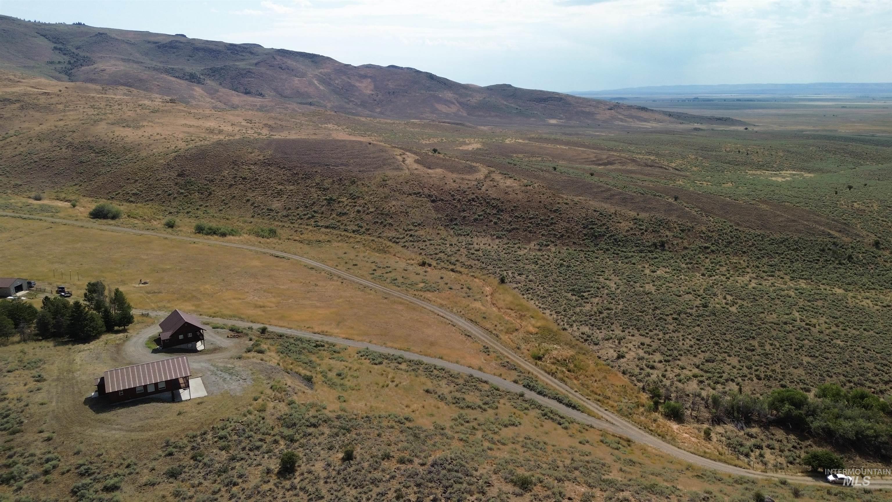 Aerial overview of property's location featuring rural landscape and a mountain backdrop