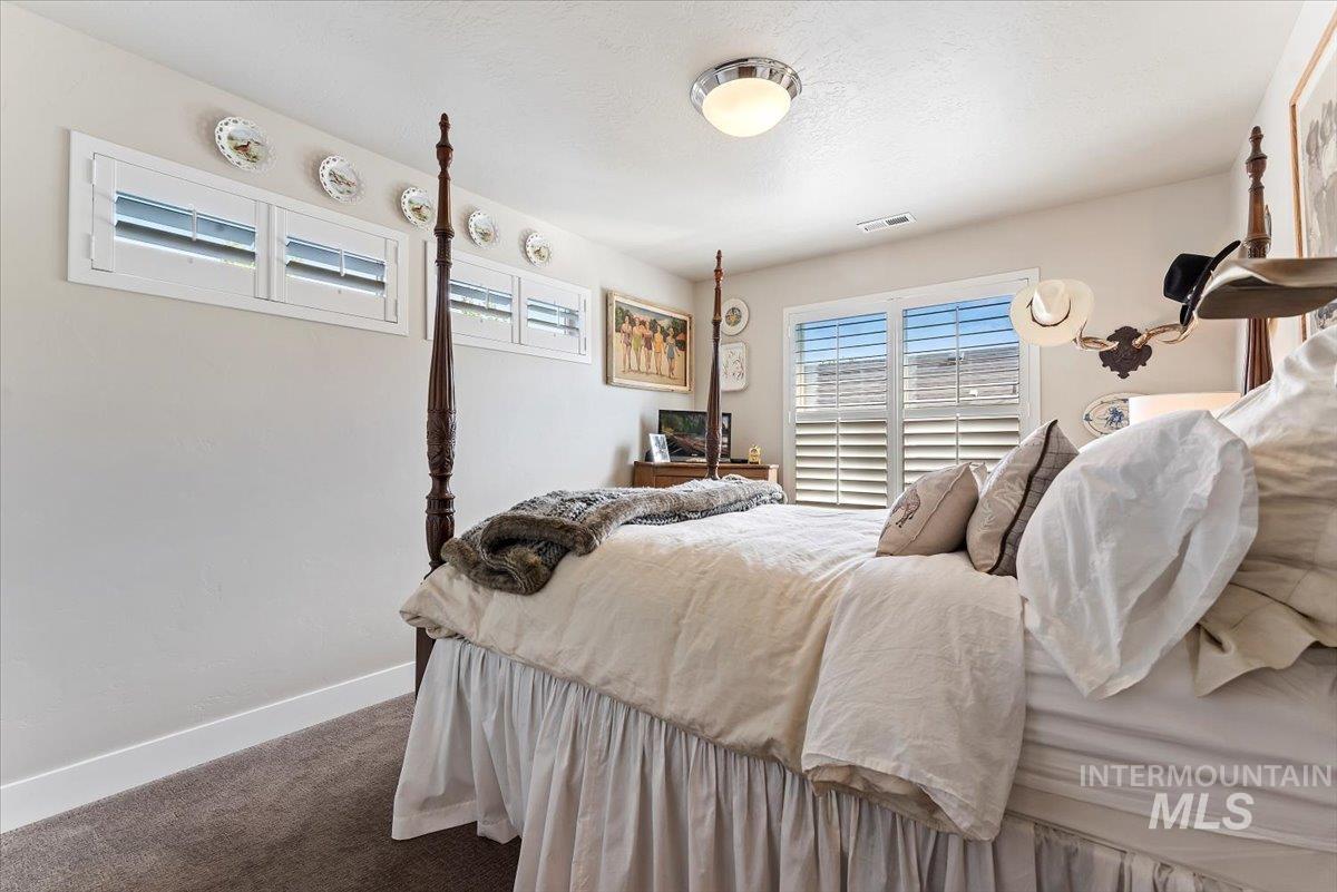 Carpeted bedroom featuring baseboards