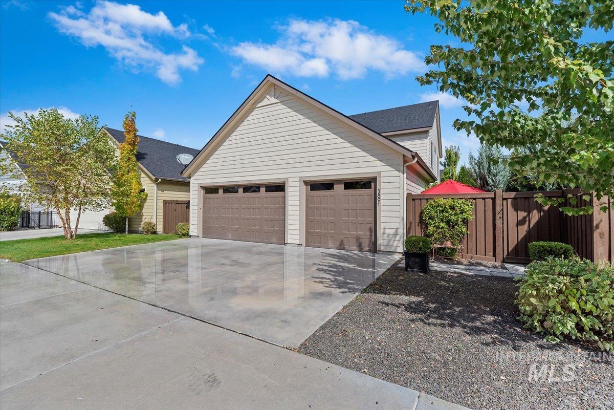 View of front of house featuring concrete driveway and an attached garage