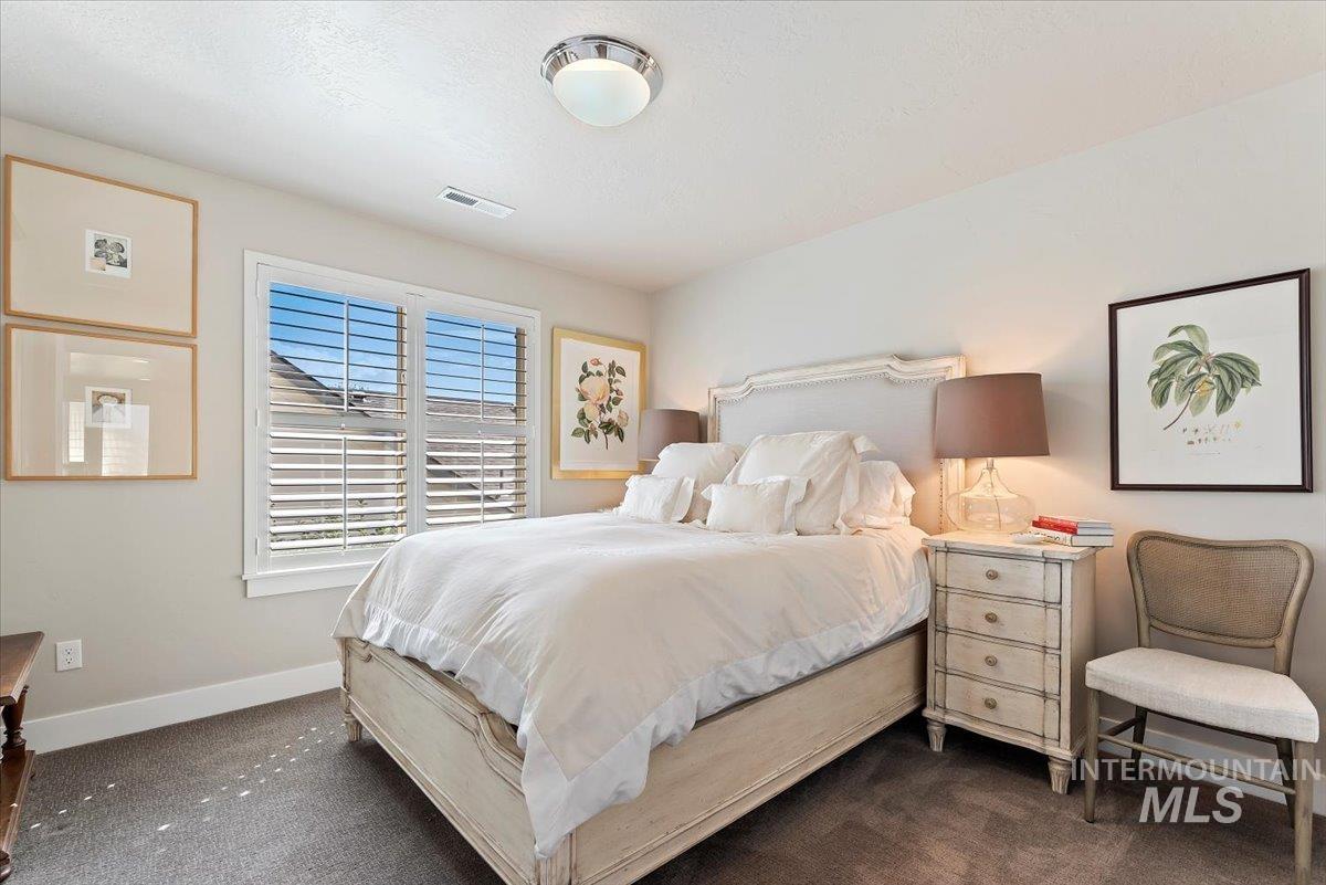 Bedroom featuring dark colored carpet