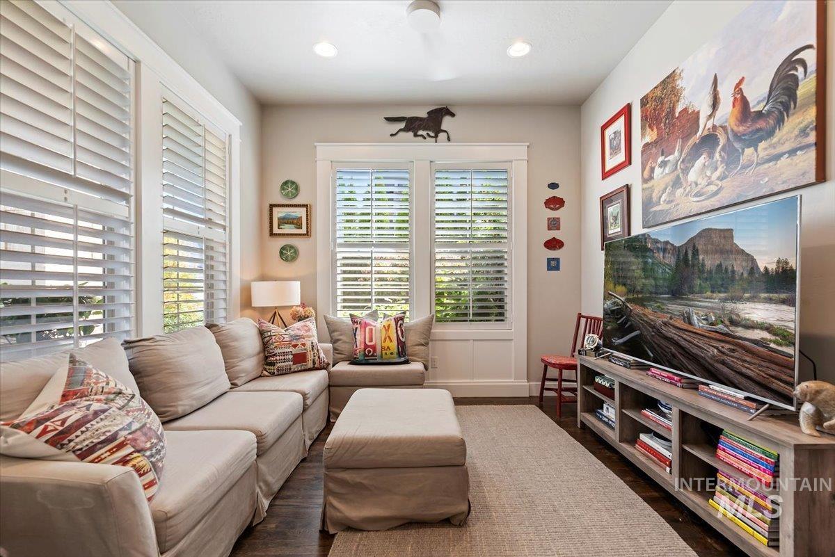 Living room with dark wood-style floors and recessed lighting