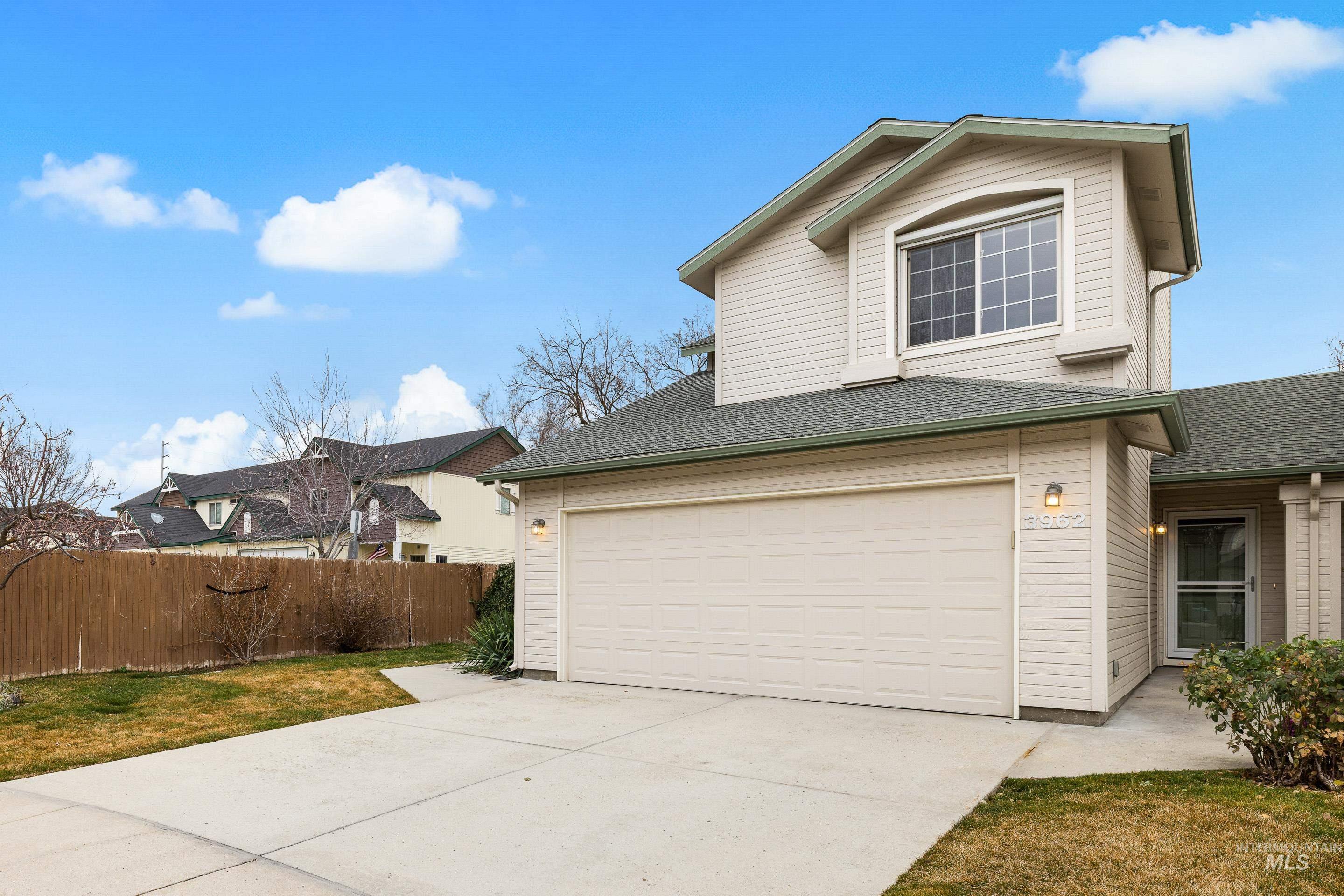 View of home's exterior with concrete driveway, roof with shingles, and a garage