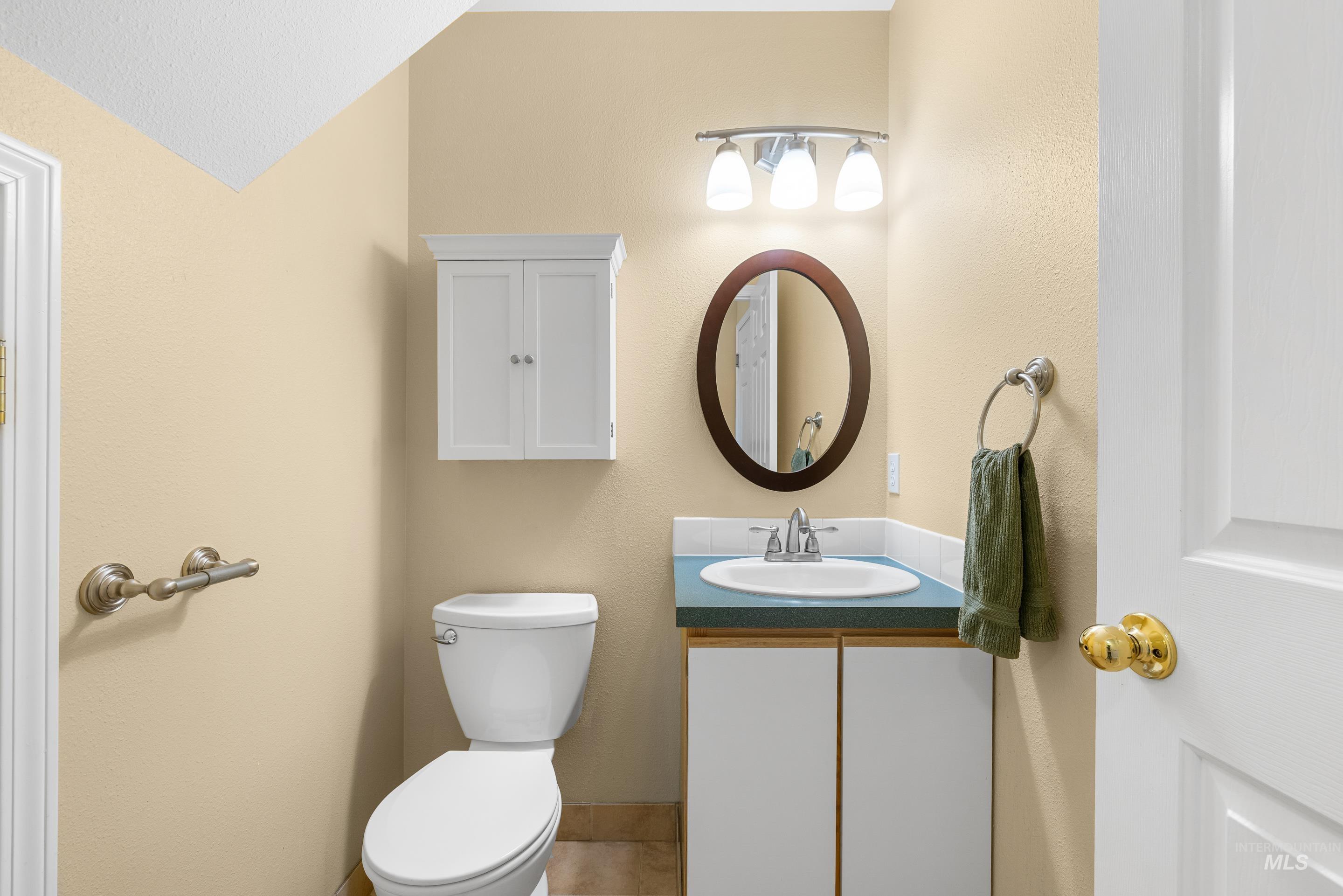 Half bath featuring vanity and toilet