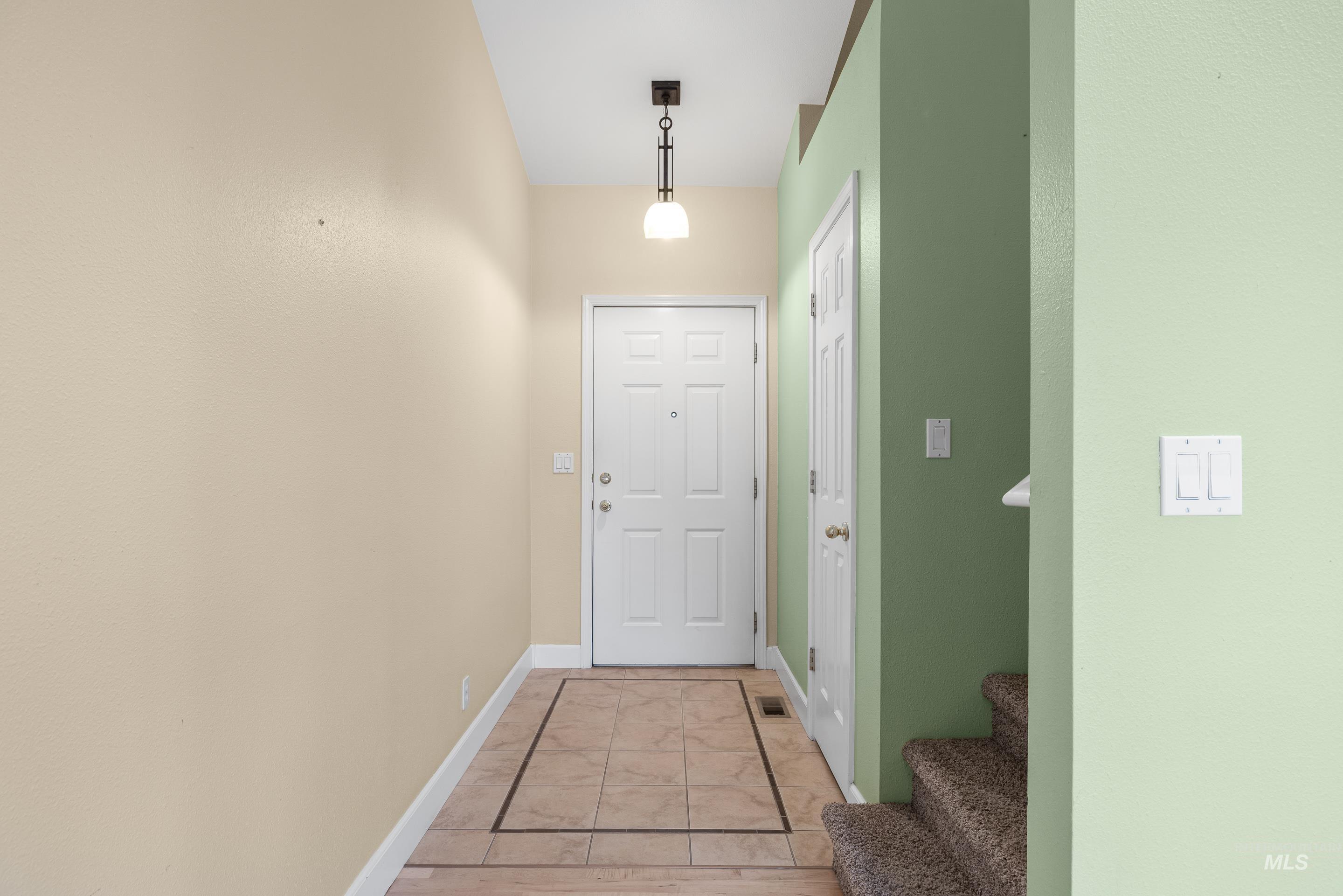 Doorway featuring baseboards and stairs