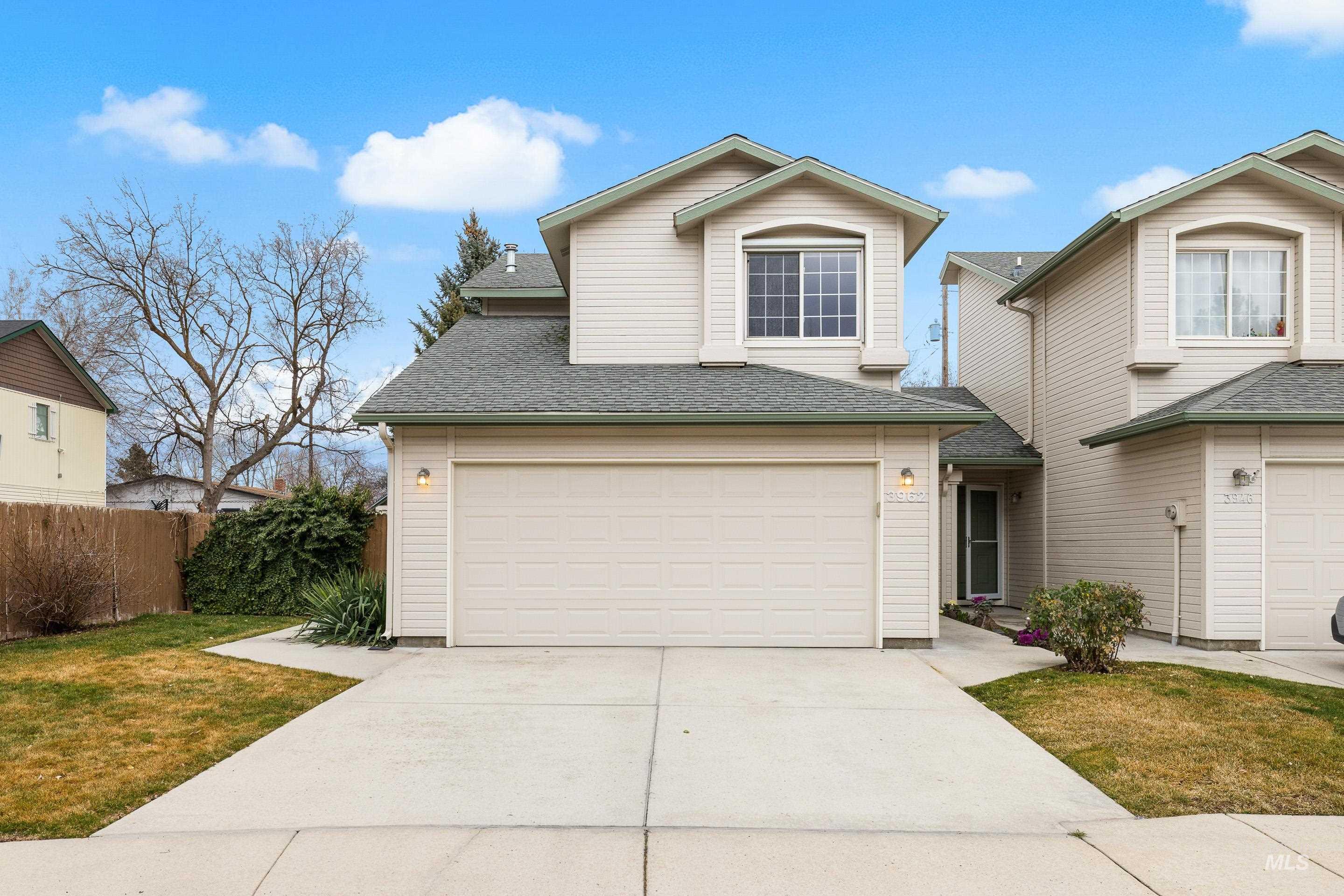 Traditional-style home with roof with shingles and concrete driveway