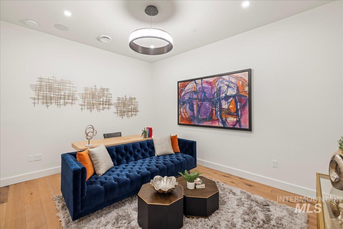 Living room with wood finished floors and recessed lighting