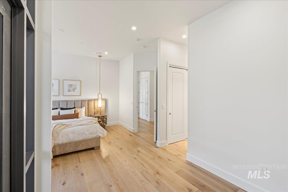 Bedroom with light wood-type flooring and recessed lighting
