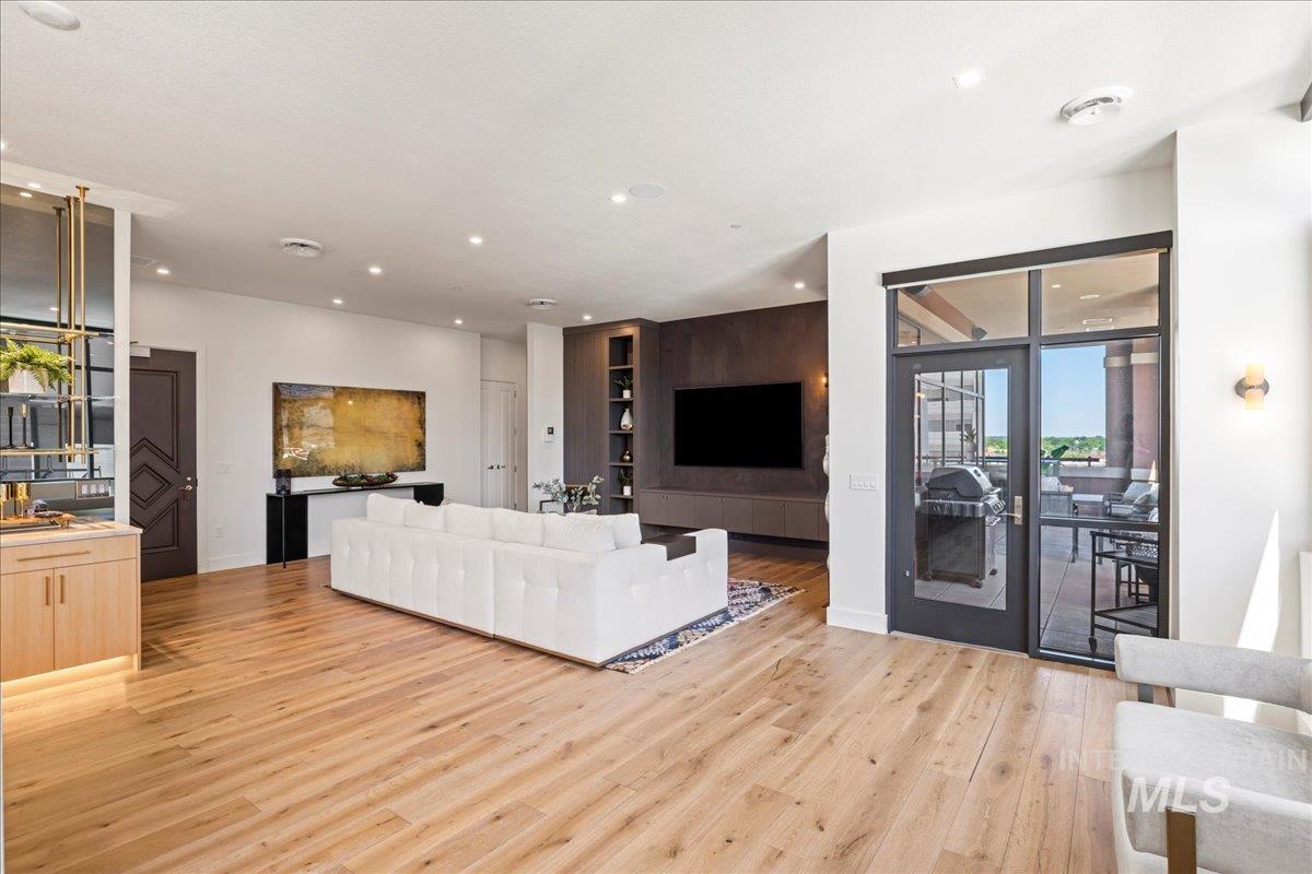 Living room featuring light wood-style flooring and recessed lighting