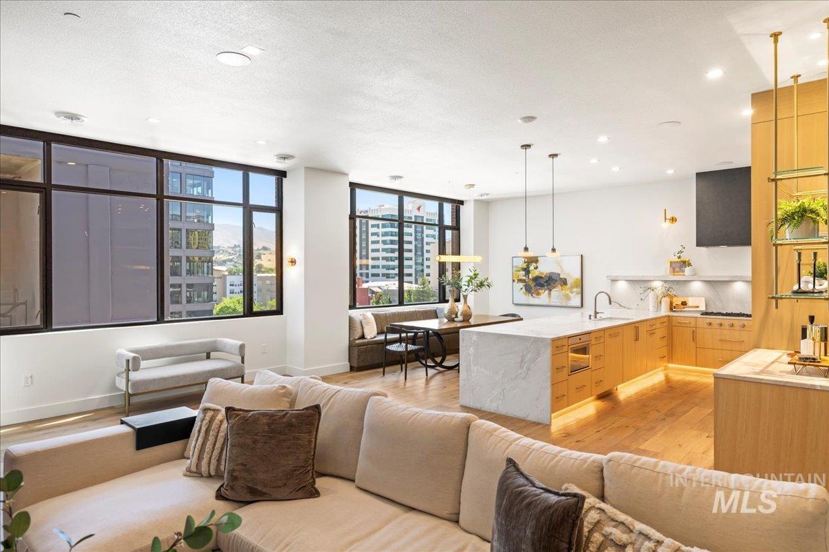 Living area featuring light wood finished floors and recessed lighting