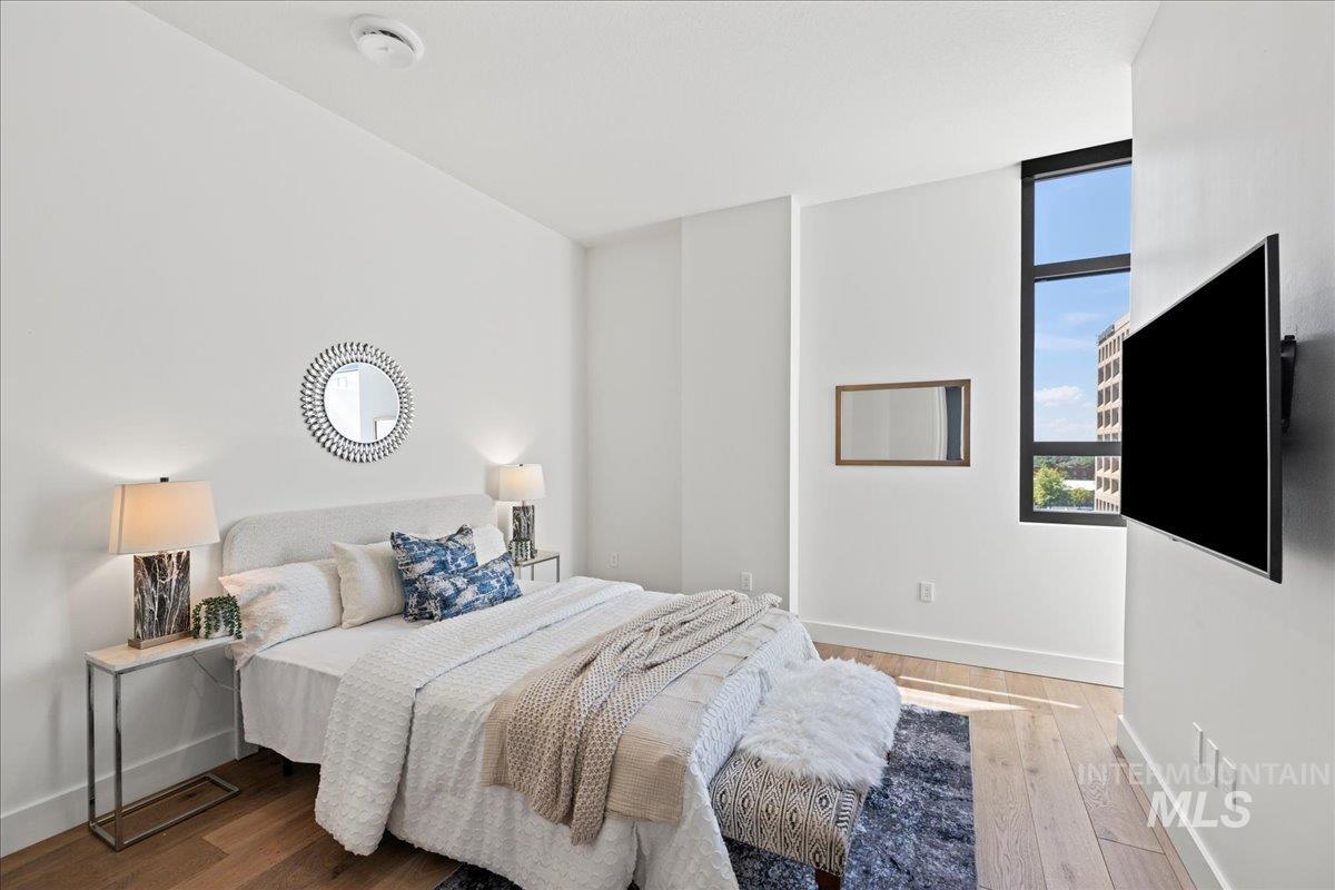 Bedroom with baseboards and wood finished floors
