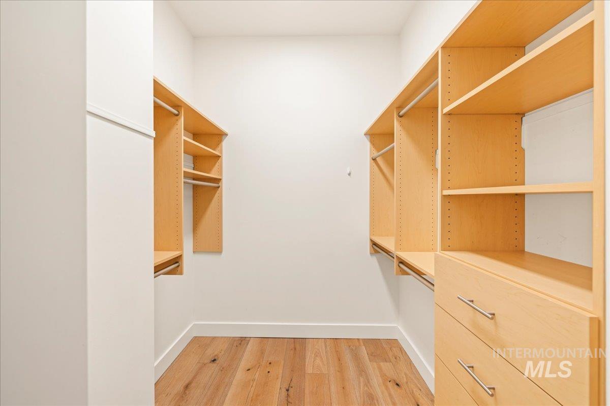 Walk in closet featuring light wood-type flooring