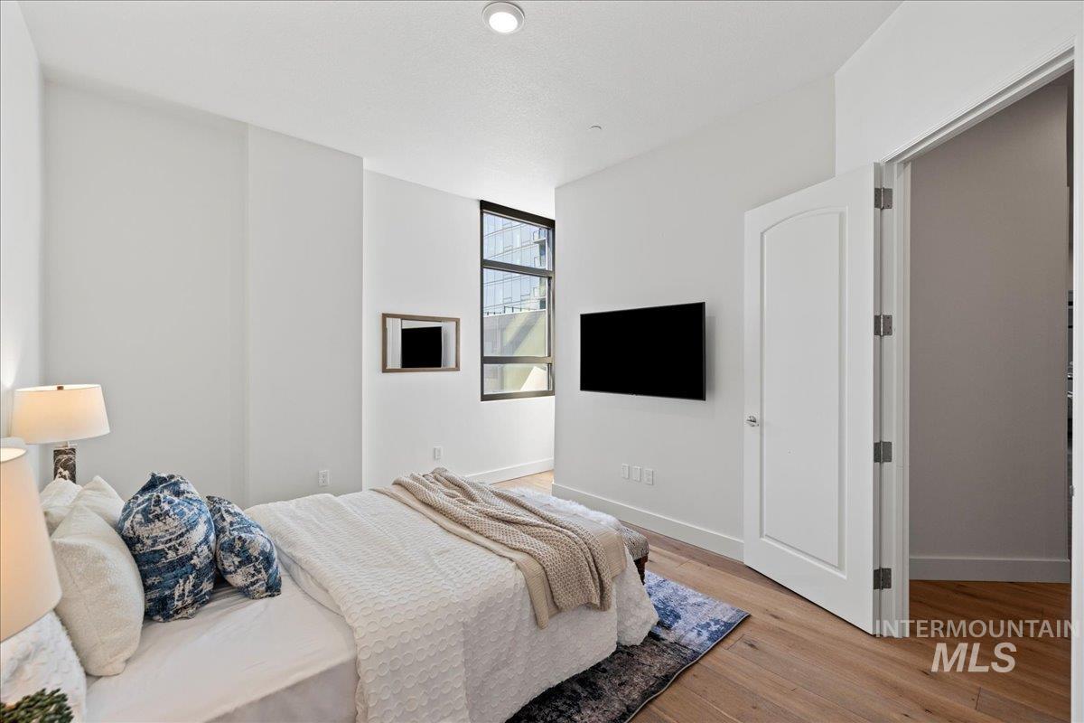 Bedroom with light wood-style flooring and baseboards