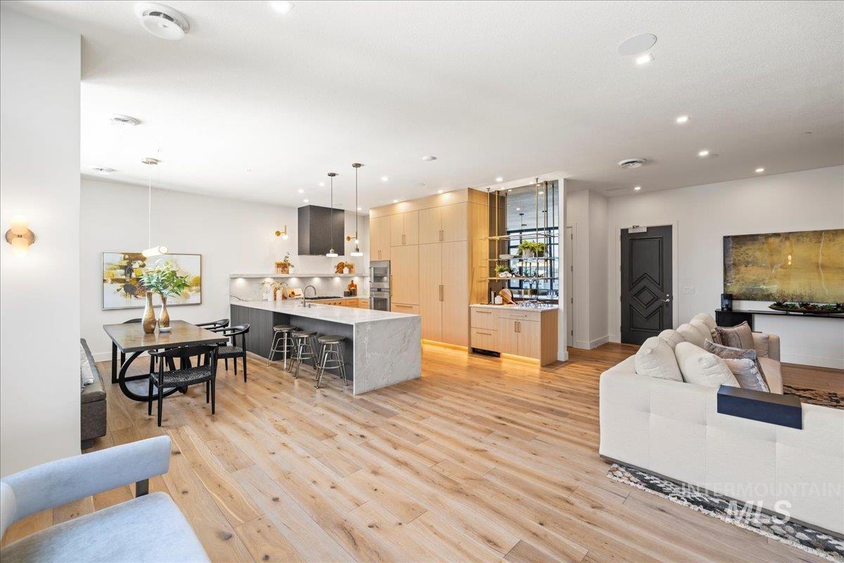 Living room featuring light wood finished floors and recessed lighting
