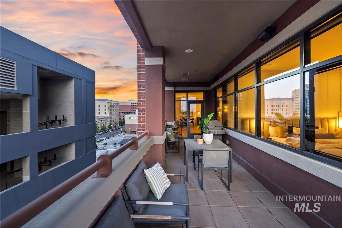 Balcony at dusk featuring a city view