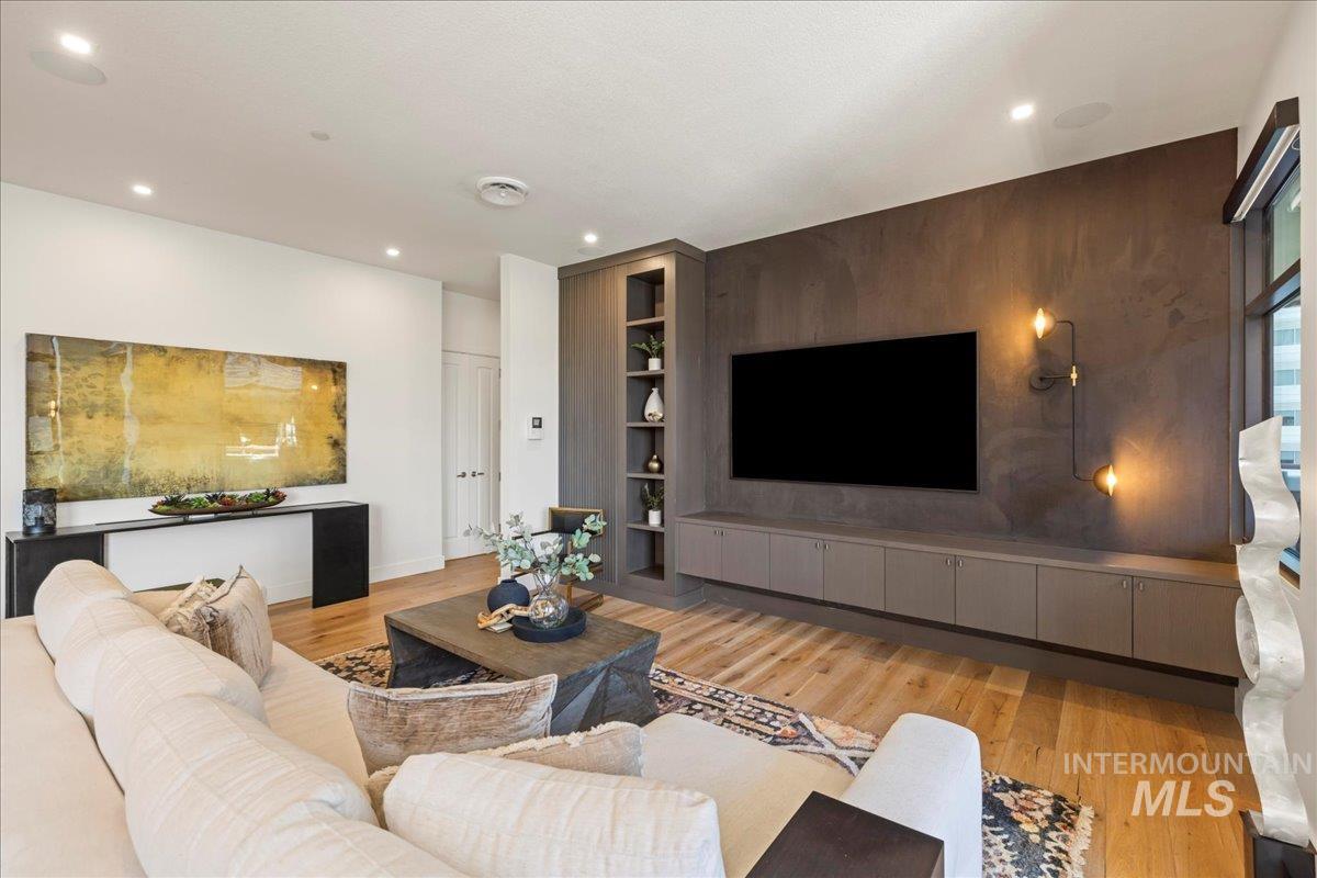 Living room featuring light wood-style floors and recessed lighting