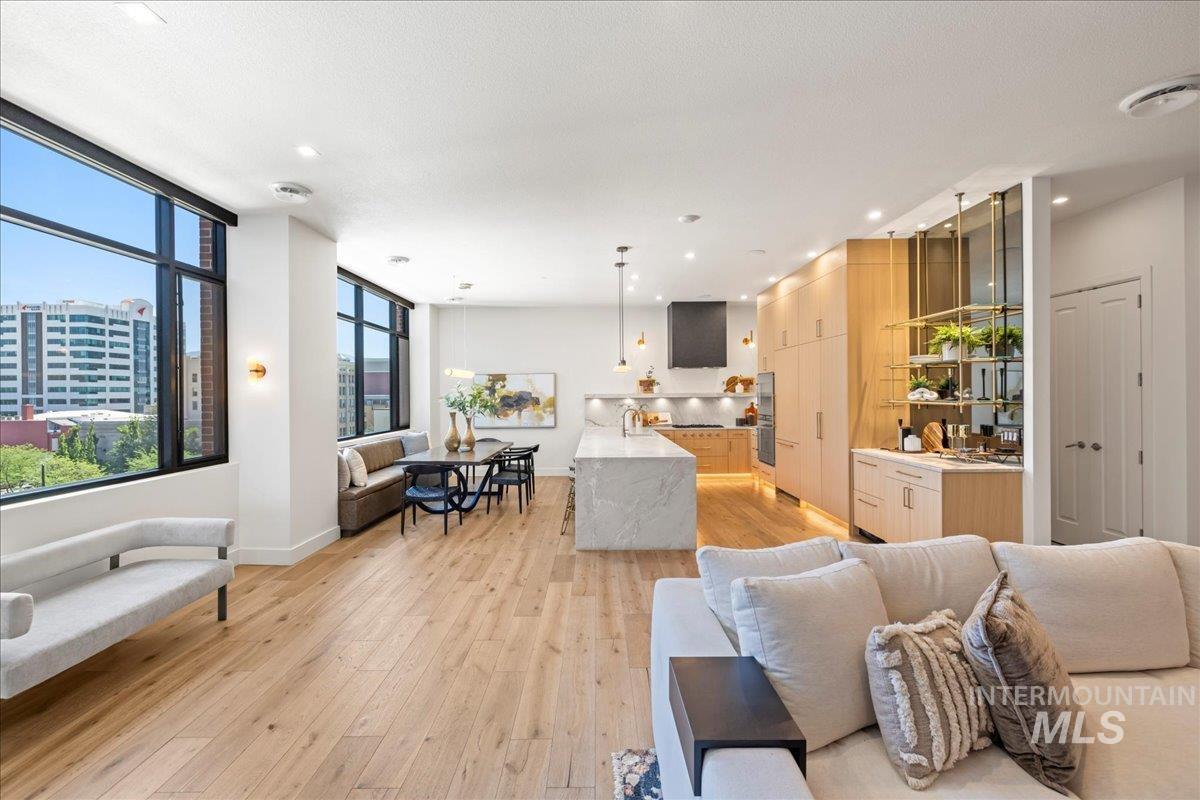 Living area featuring light wood-type flooring, recessed lighting, and a view of city