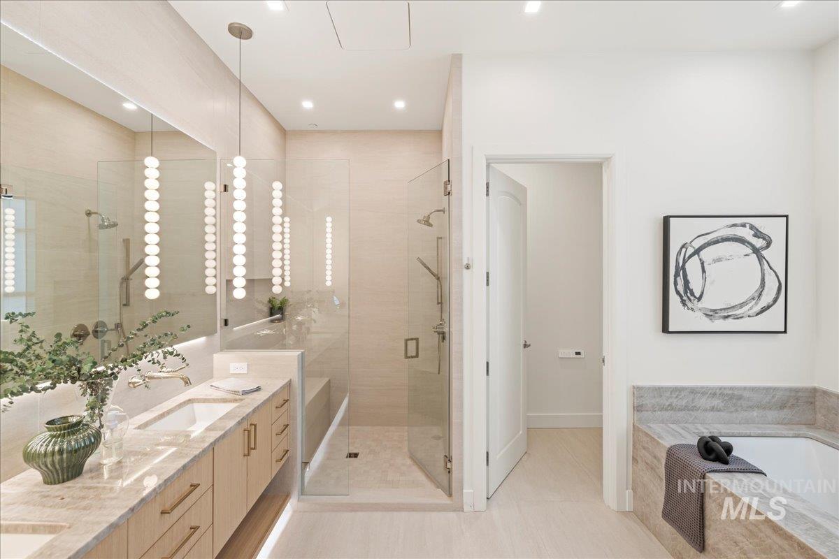 Full bathroom featuring a bath, a stall shower, double vanity, recessed lighting, and tile patterned flooring