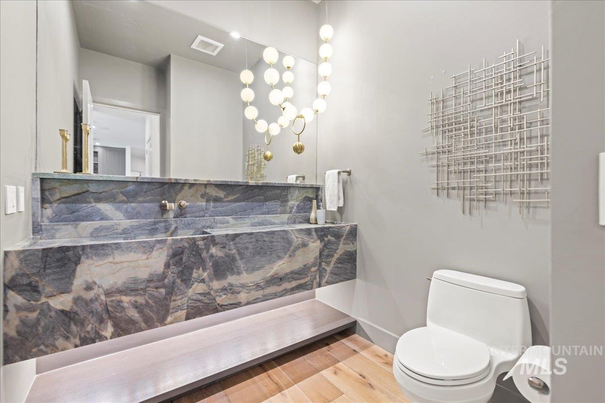 Bathroom featuring toilet and wood finished floors