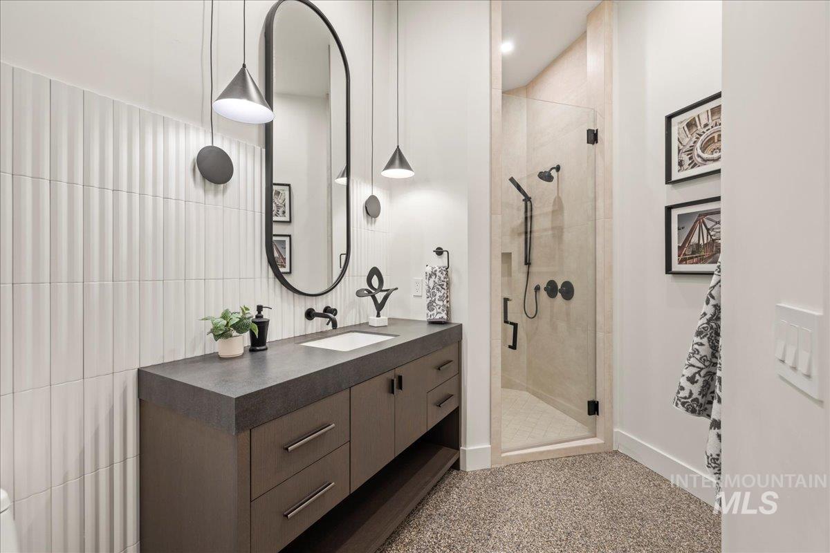 Bathroom featuring vanity and a shower stall