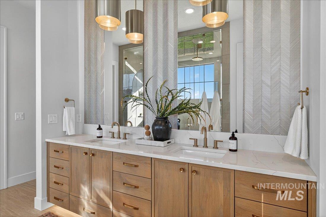 Full bathroom featuring double vanity and light wood-style flooring