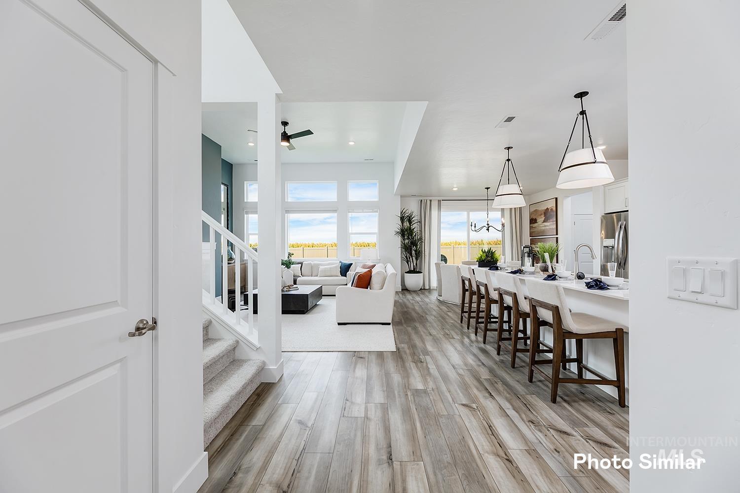 Foyer entrance featuring stairway, light wood finished floors, ceiling fan, and recessed lighting