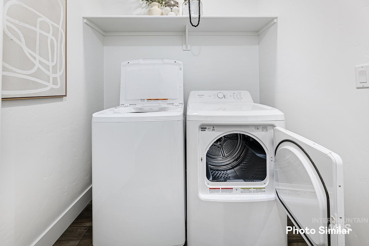 Laundry area with independent washer and dryer and wood finished floors