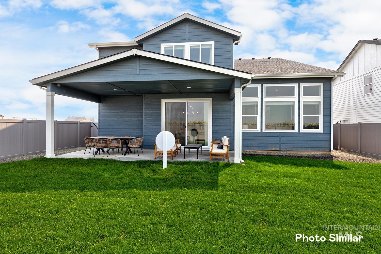 Rear view of house featuring a patio area and a fenced backyard