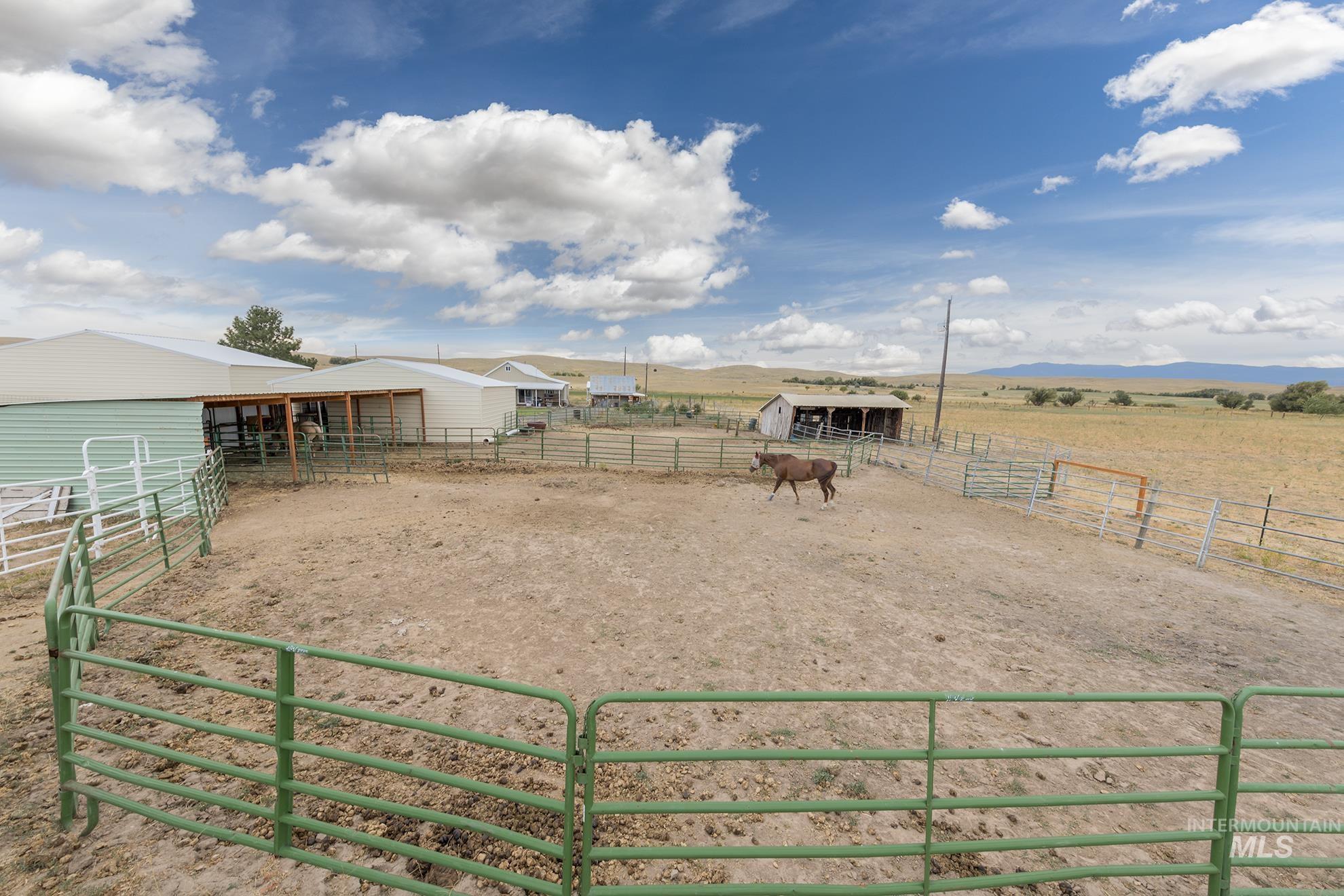 View of yard with an exterior structure, an outbuilding, a view of rural / pastoral area, and an enclosed horse arena