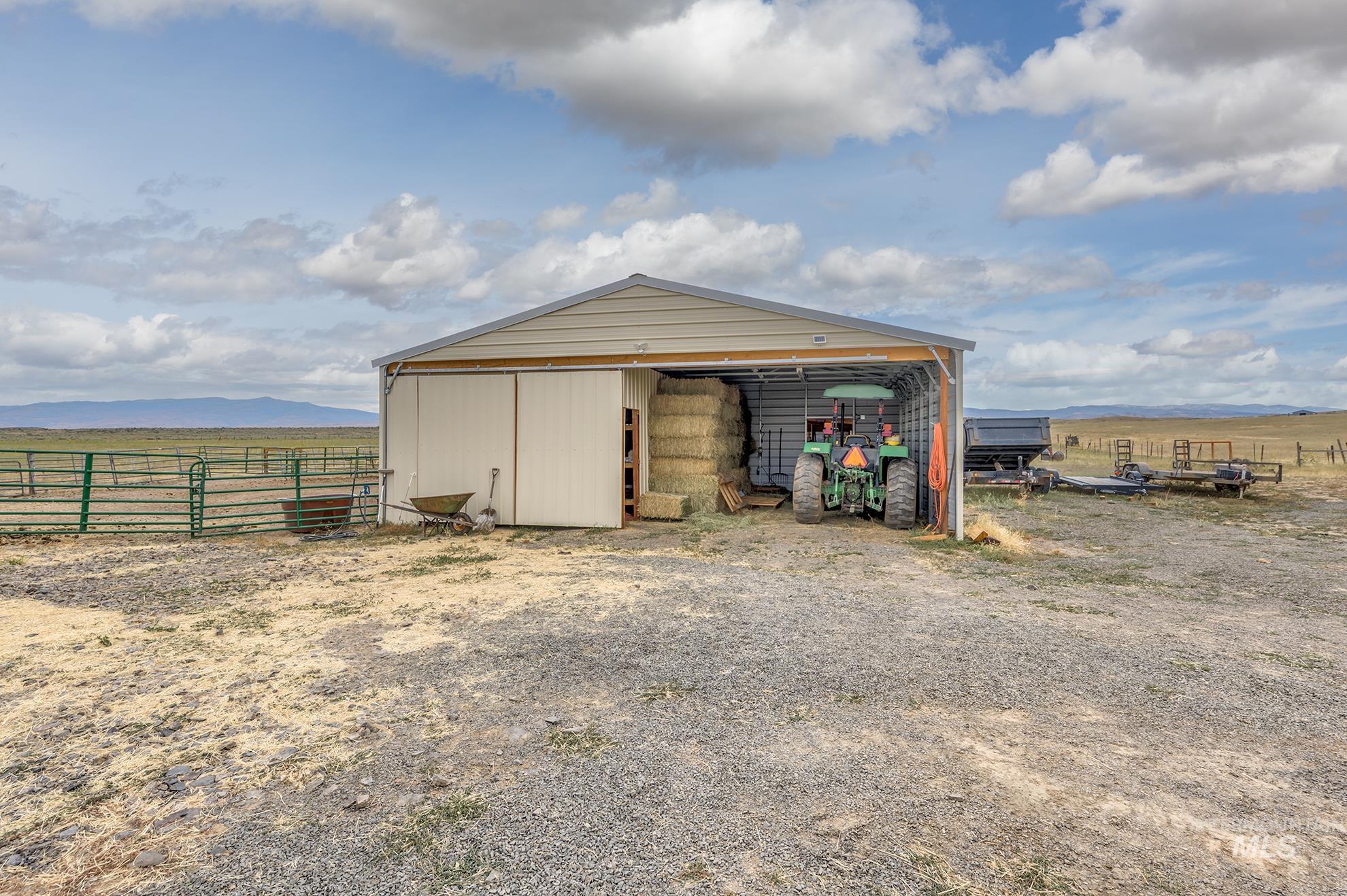 View of pole building featuring a mountain view and a view of rural / pastoral area