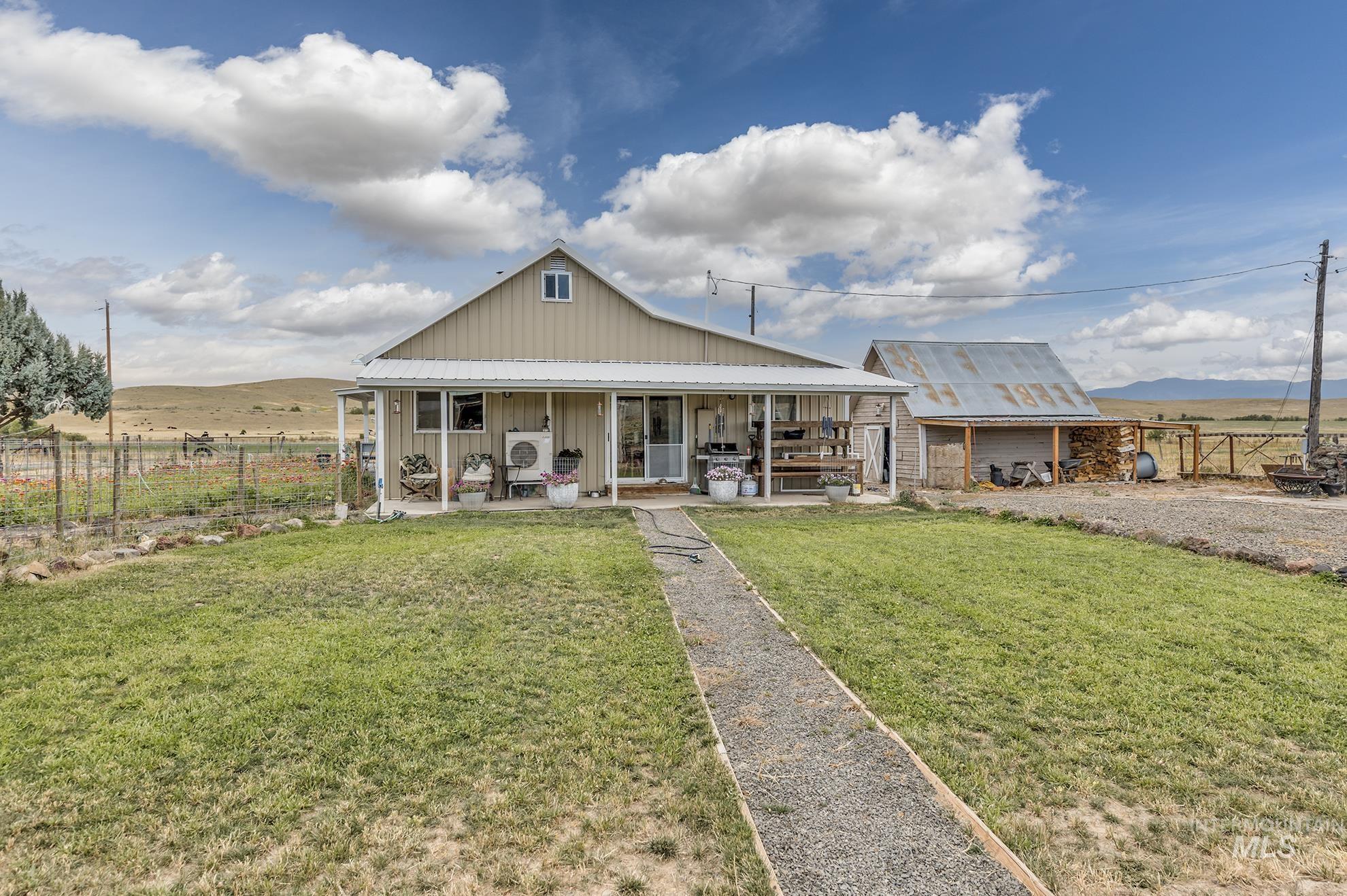 View of front of house featuring board and batten siding, a mountain view, and a porch
