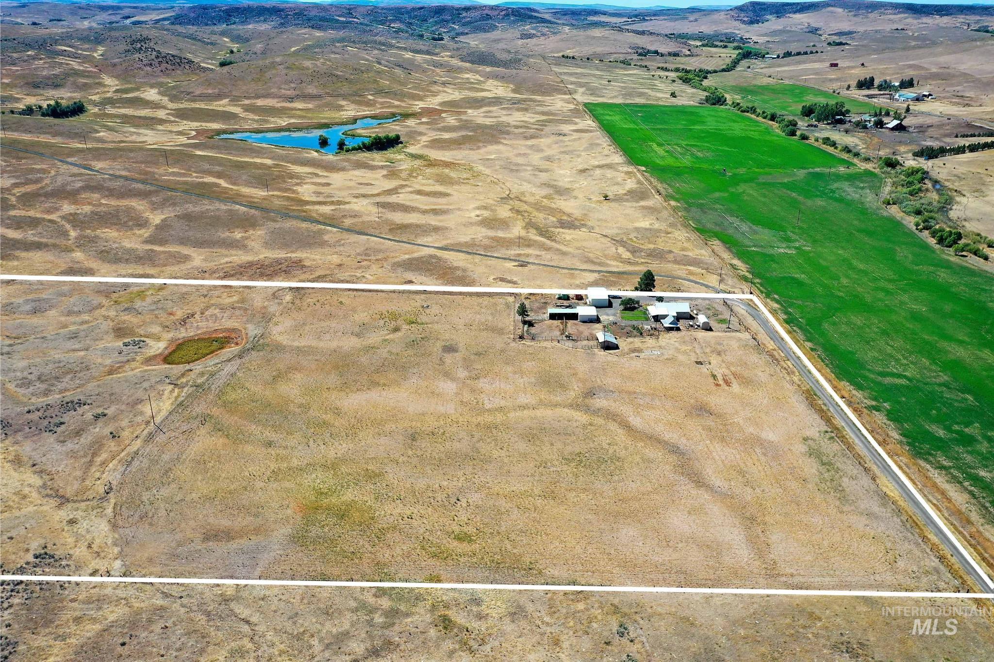 Aerial view of sparsely populated area with property parcel outlined