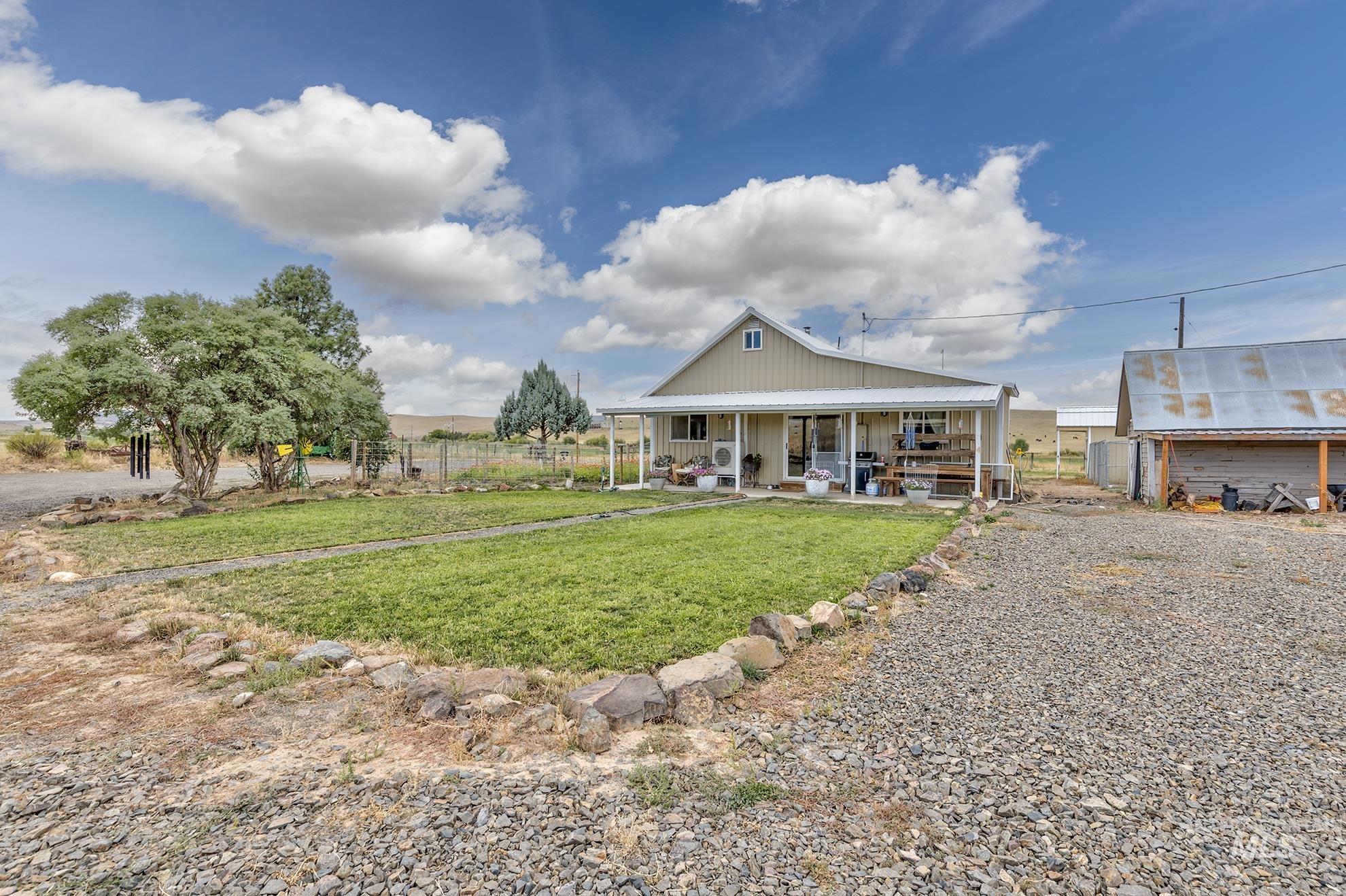 View of front of house featuring covered porch and board and batten siding