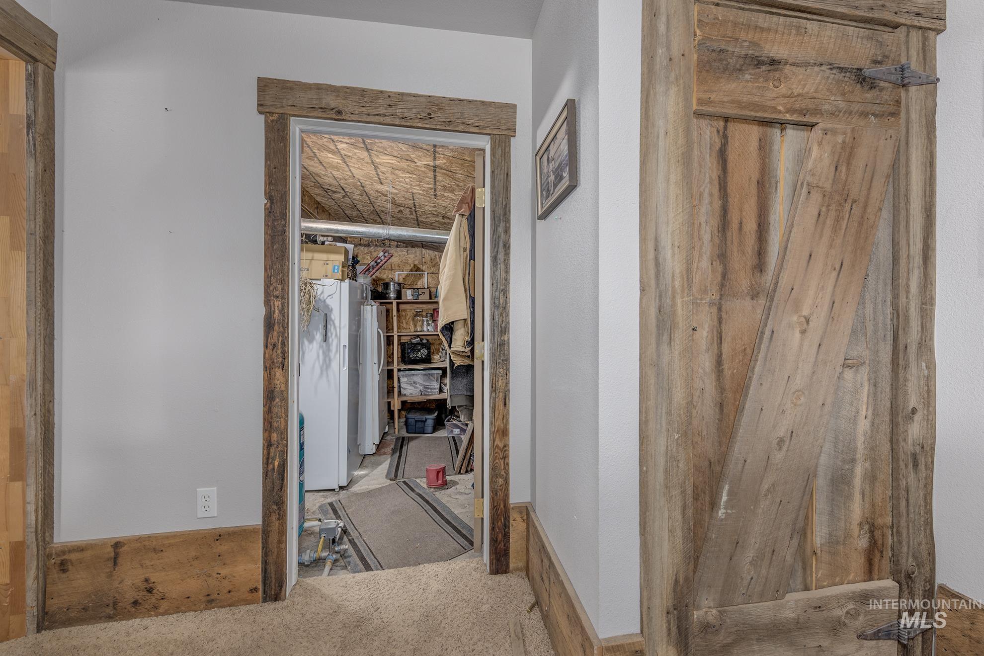 Corridor with carpet flooring and baseboards