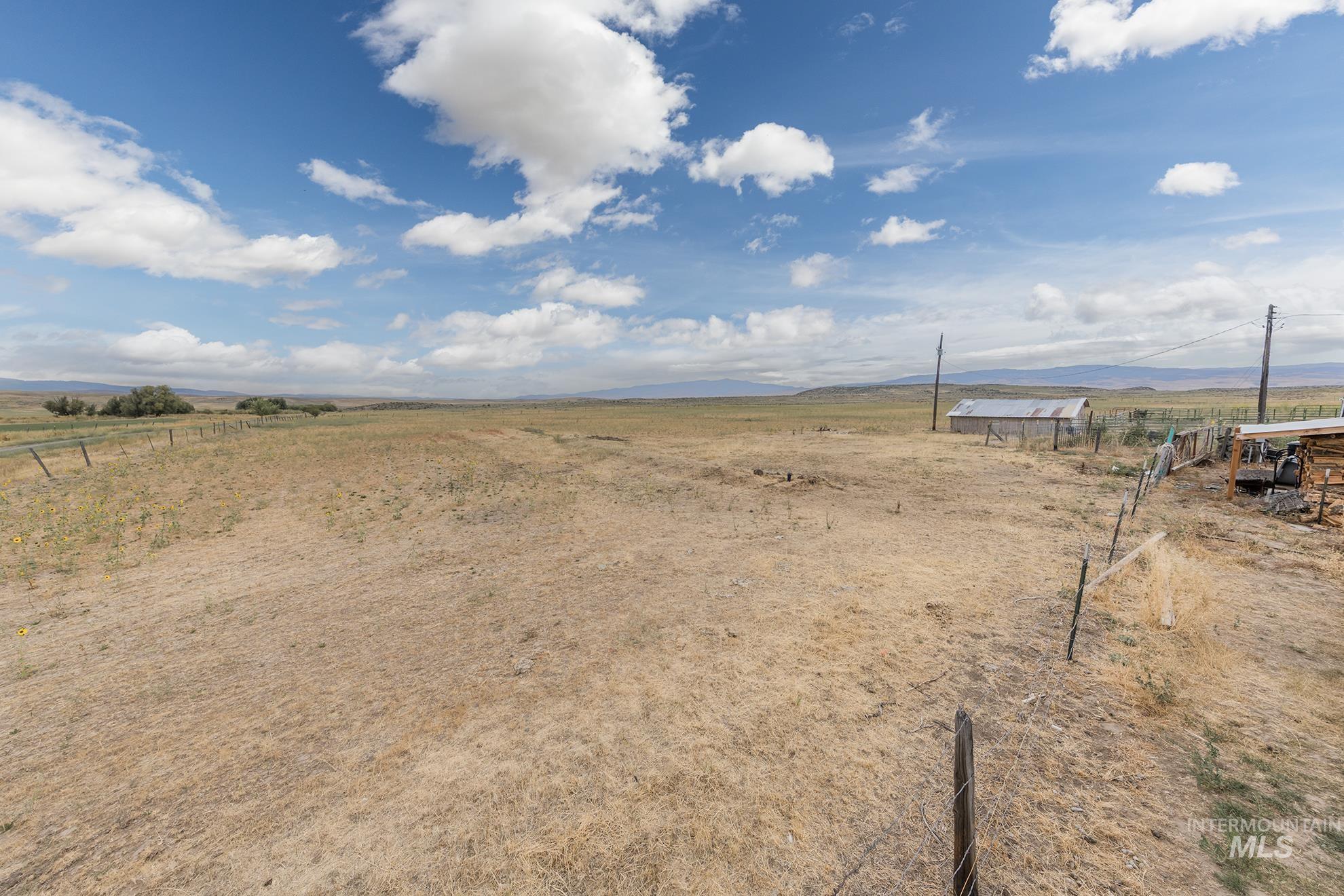 View of yard featuring a view of rural / pastoral area and a mountain view