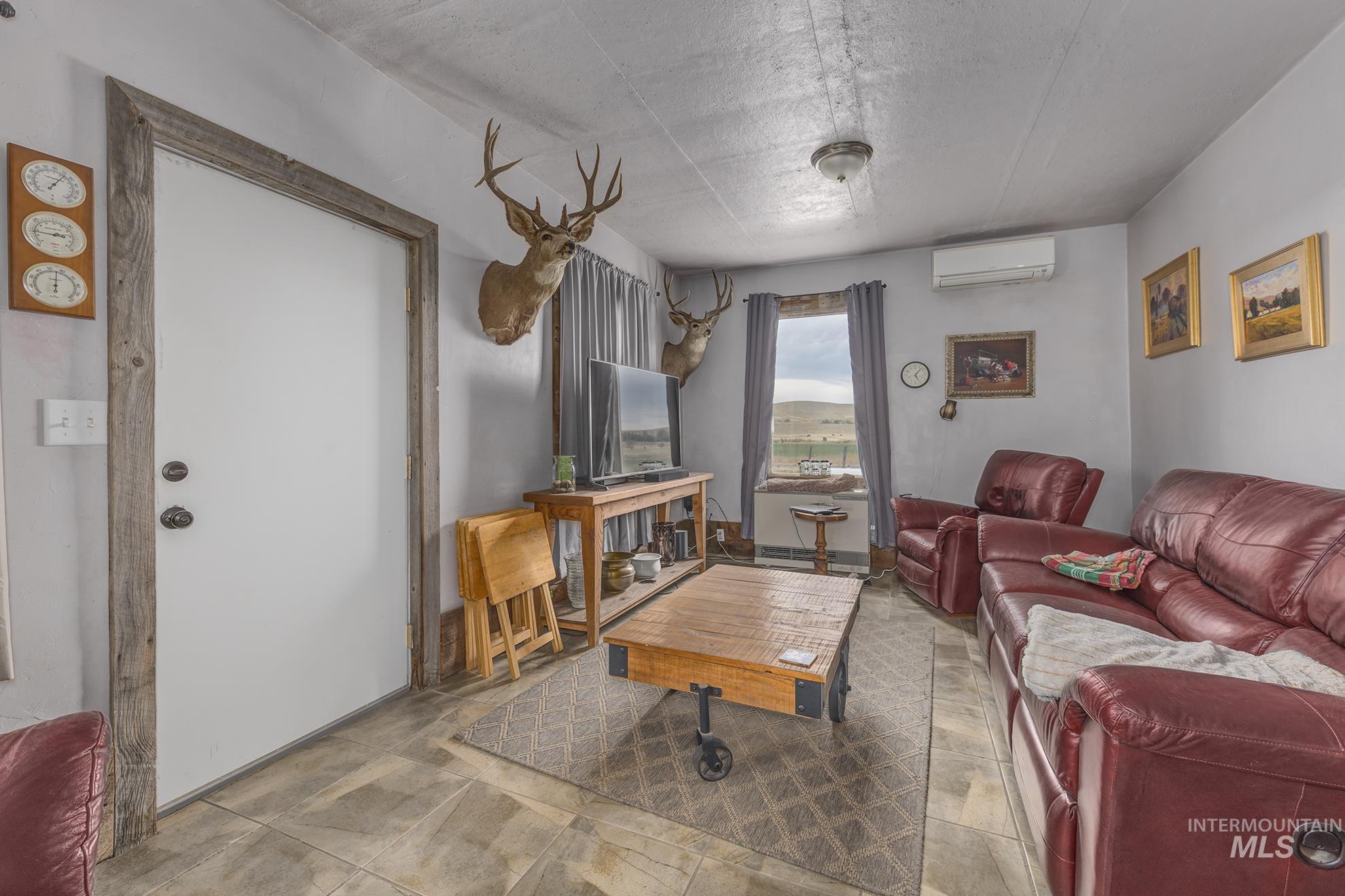 Living area with a textured ceiling and a wall unit AC