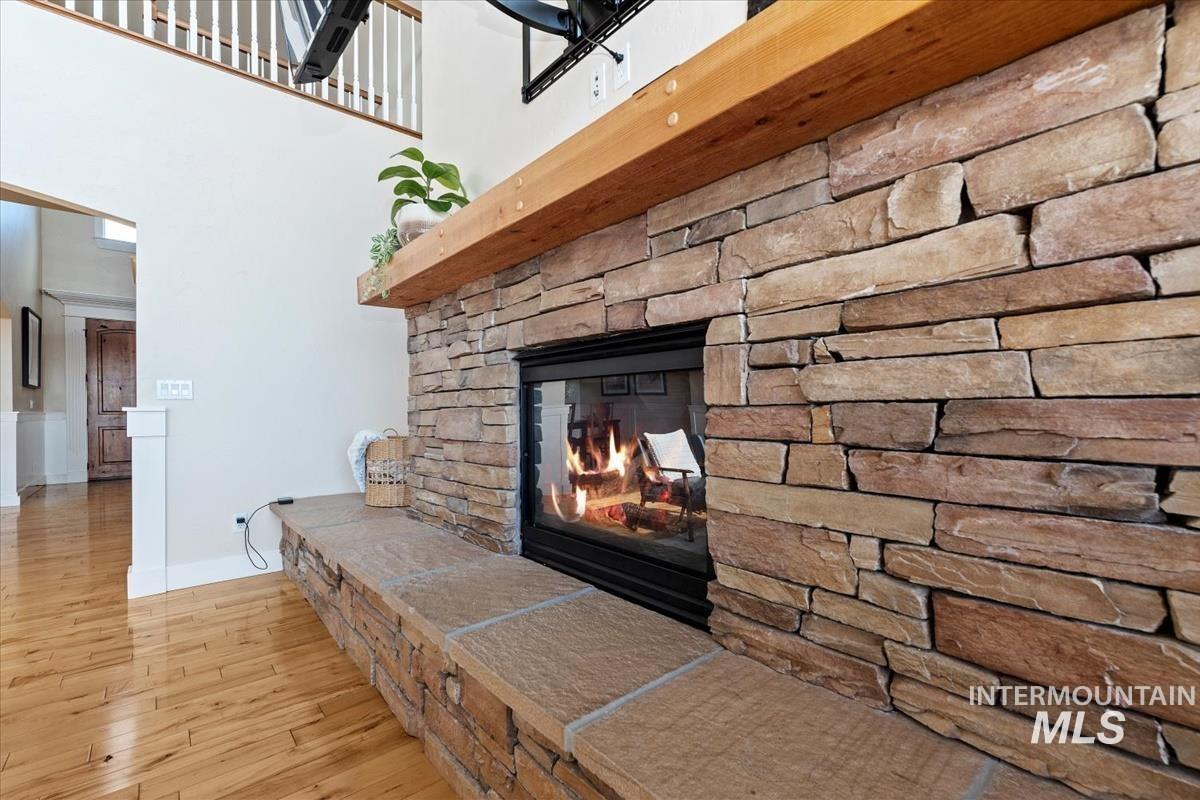 Detailed view of wood finished floors and a fireplace
