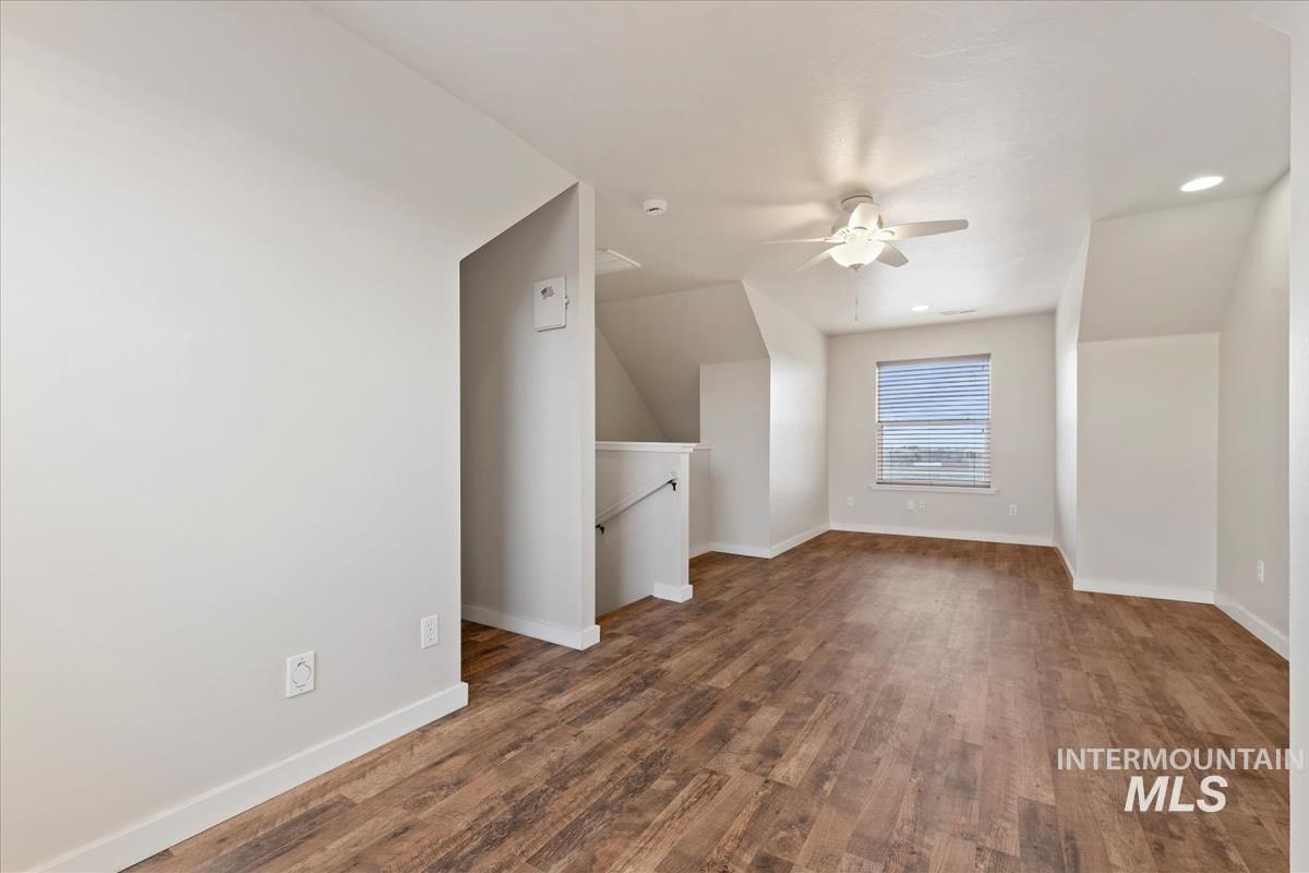 Additional living space featuring dark wood finished floors, recessed lighting, and a ceiling fan