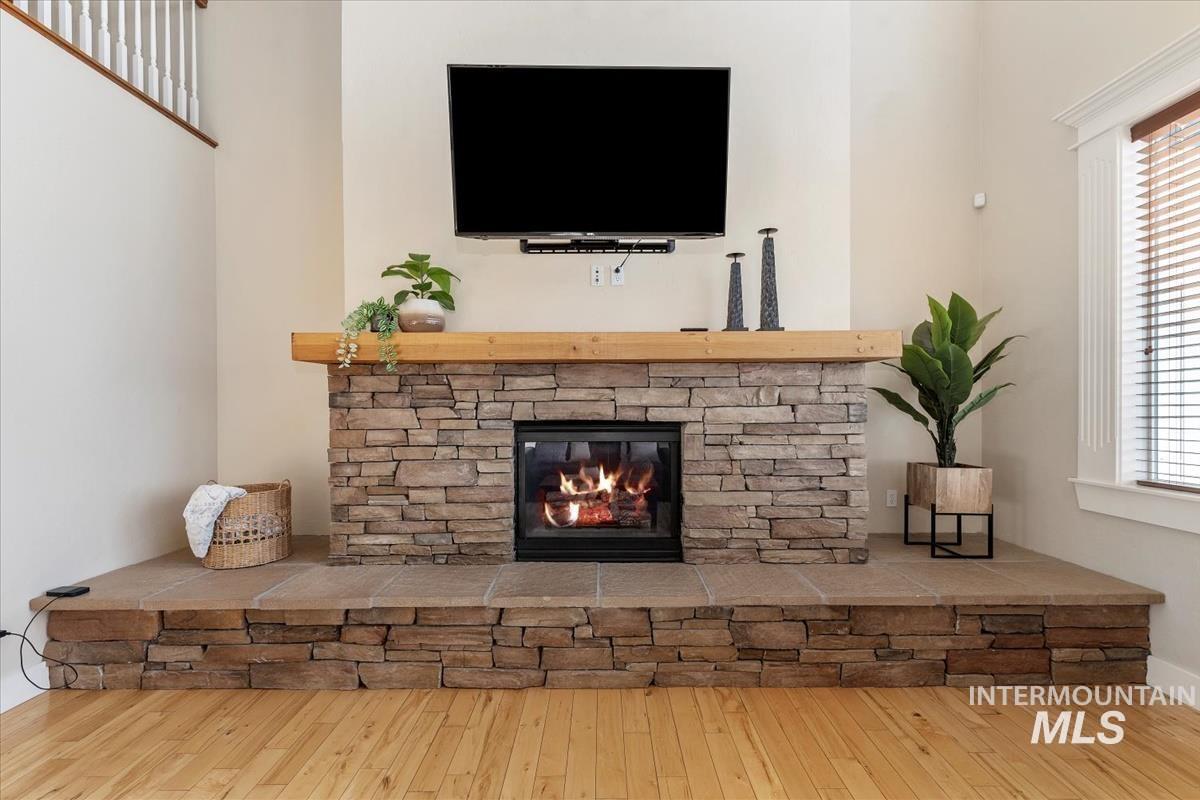 Detailed view of a stone fireplace and wood finished floors