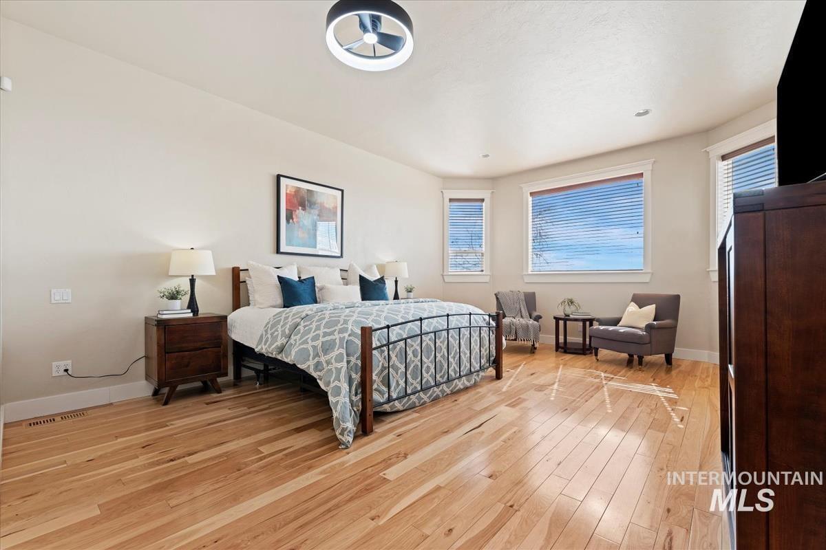 Bedroom with light wood finished floors and baseboards